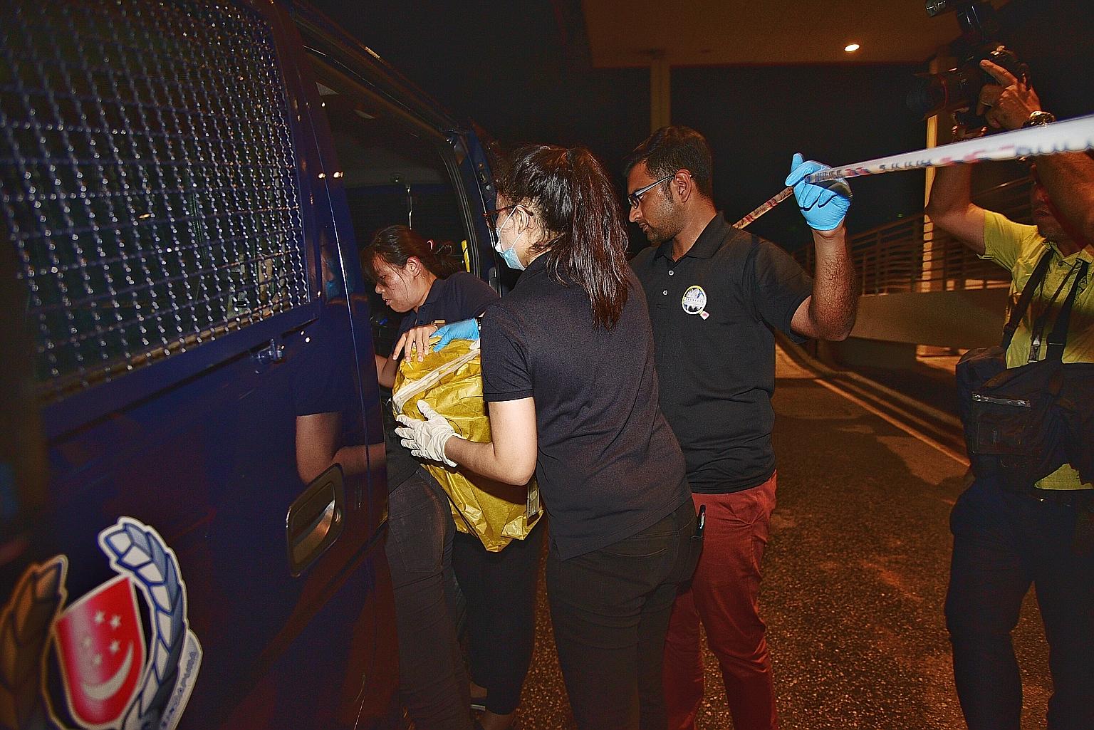 The police taking away several items from the crime scene at the International Furniture Centre building on Monday.