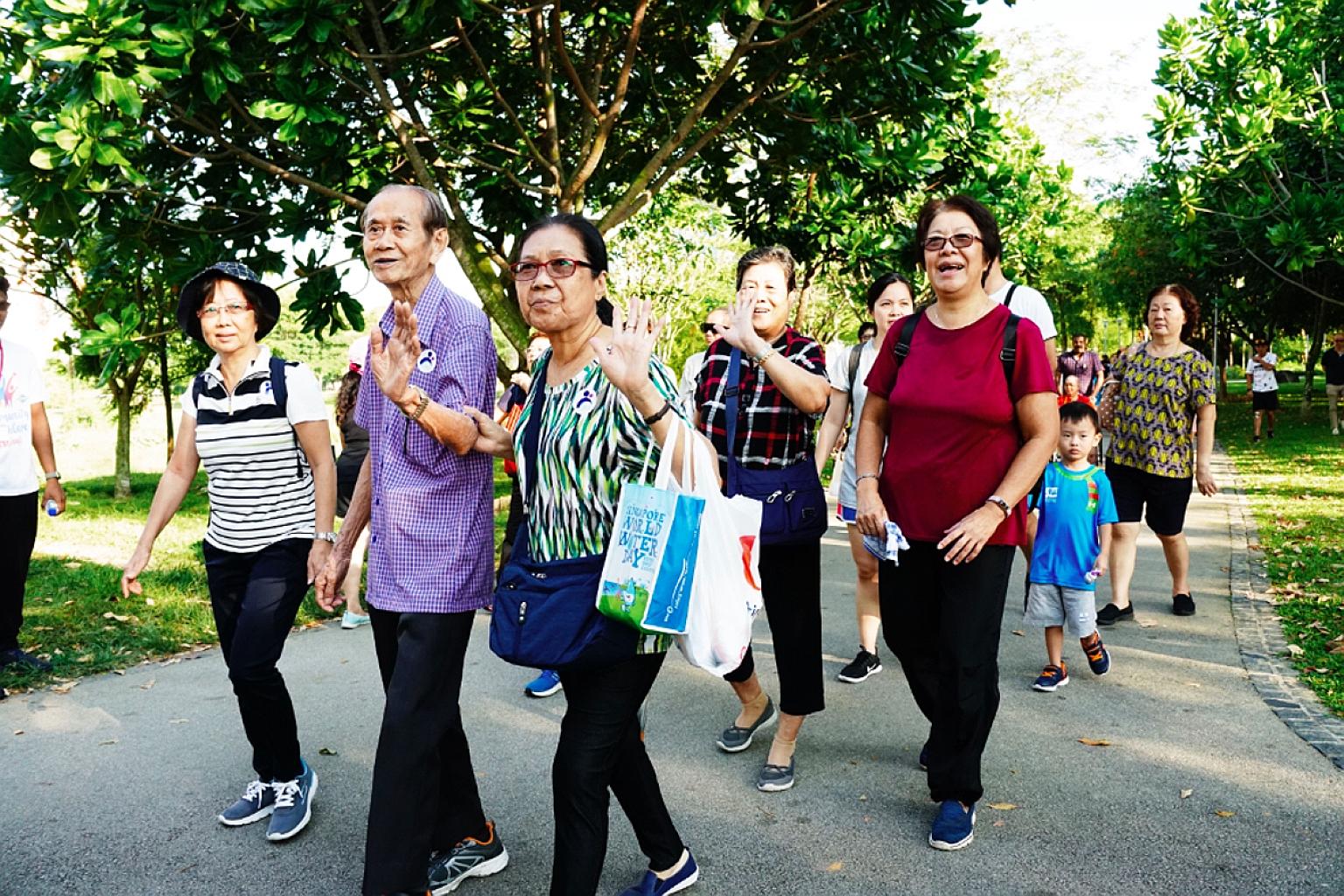 Participants on a 30-minute stroll during Walk 2 Remember at Bishan-Ang Mo Kio Park yesterday. More than 300 people took part in the walkathon, including seniors and their caregivers.