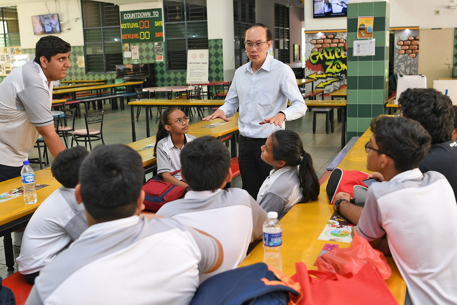 Mr Tan Chor Pang, principal of Boon Lay Secondary School, with some of its students. During his 35 years as an educator, he has taught students from both the Normal and Express streams and has never minded teaching weaker children, saying: "I felt li
