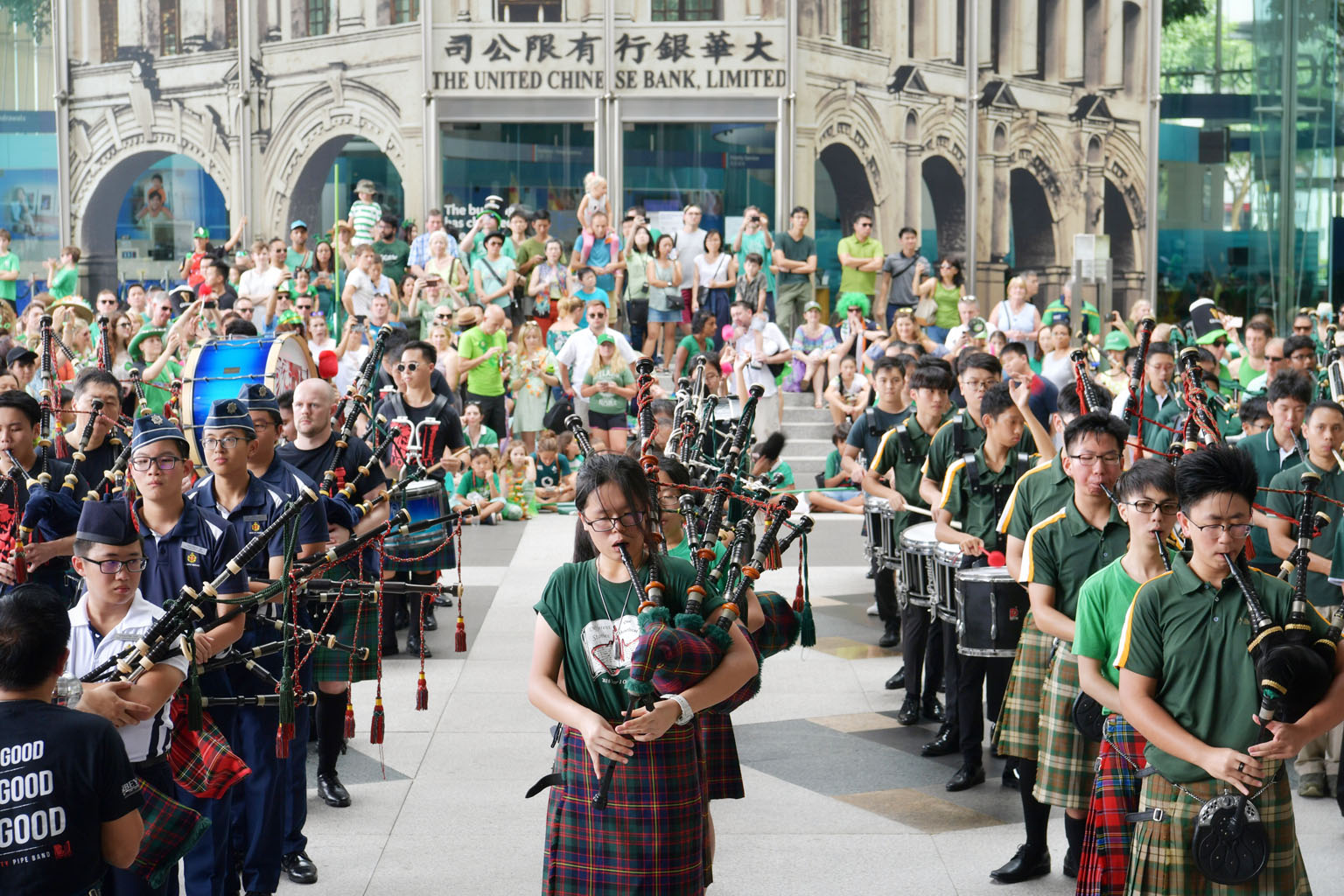 Members of pipe organ bands from several schools in Singapore, including St Joseph's Institution and Raffles Girls' School, performing at the St Patrick's Day parade at UOB Plaza in Raffles Place. About 400 people from the Irish community in Singapor