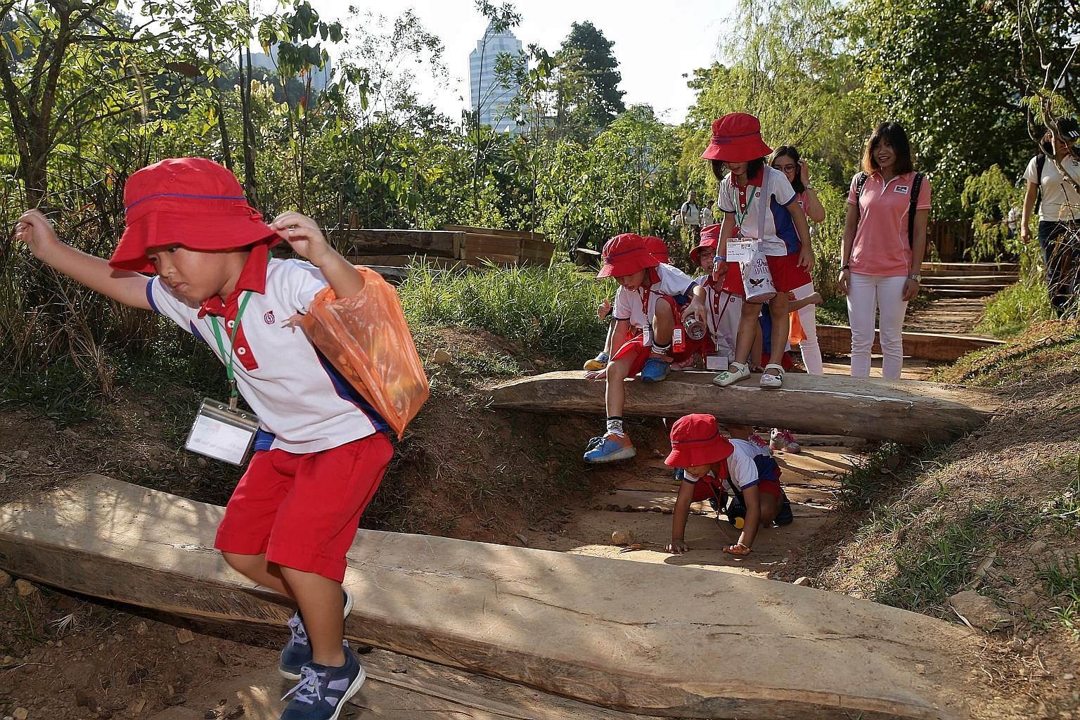 Pre-schoolers from PCF Sparkletots enjoyed a fun day in the sun yesterday at Log Valley, one of the nine different play areas in the National Parks Board's (NParks) new Nature Playgarden at HortPark in Alexandra. Mr Desmond Lee, Minister for Social a