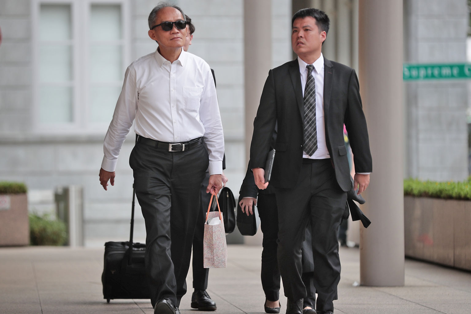 Former Ipco International interim chief executive Goh Hin Calm (far left) arriving at the Supreme Court with his lawyer Adrian Wee yesterday.