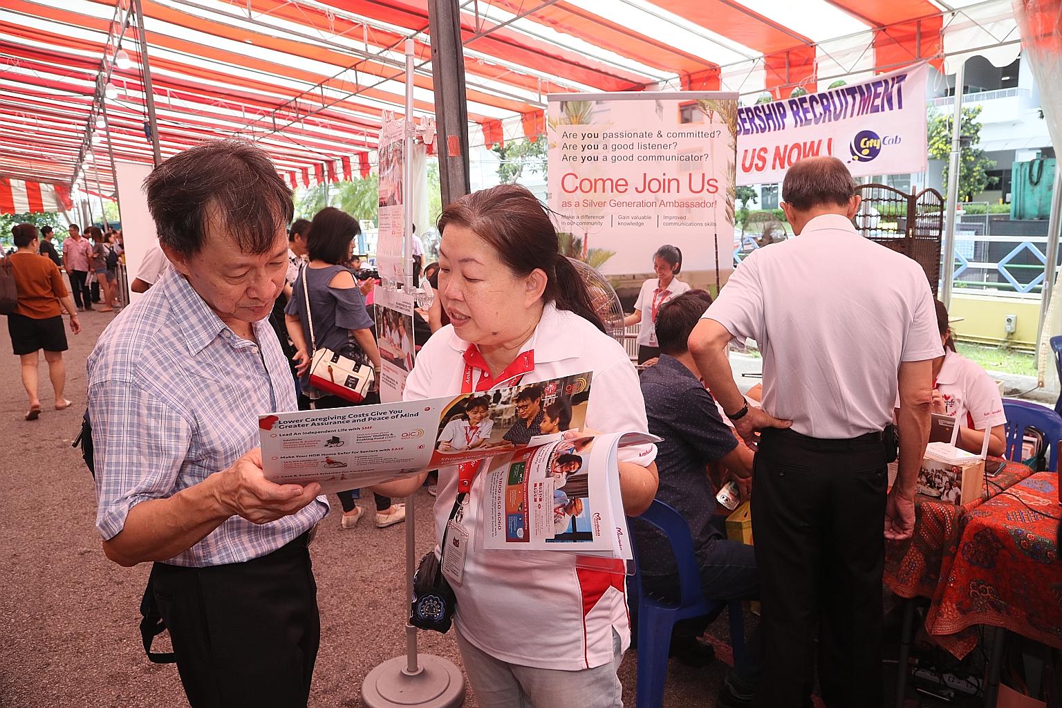 A Silver Generation Ambassador explaining the Merdeka Generation Package to a participant yesterday at a workplace engagement session by the Silver Generation Office at ComfortDelGro's premises in Sin Ming Drive. Such engagement sessions will be ramp
