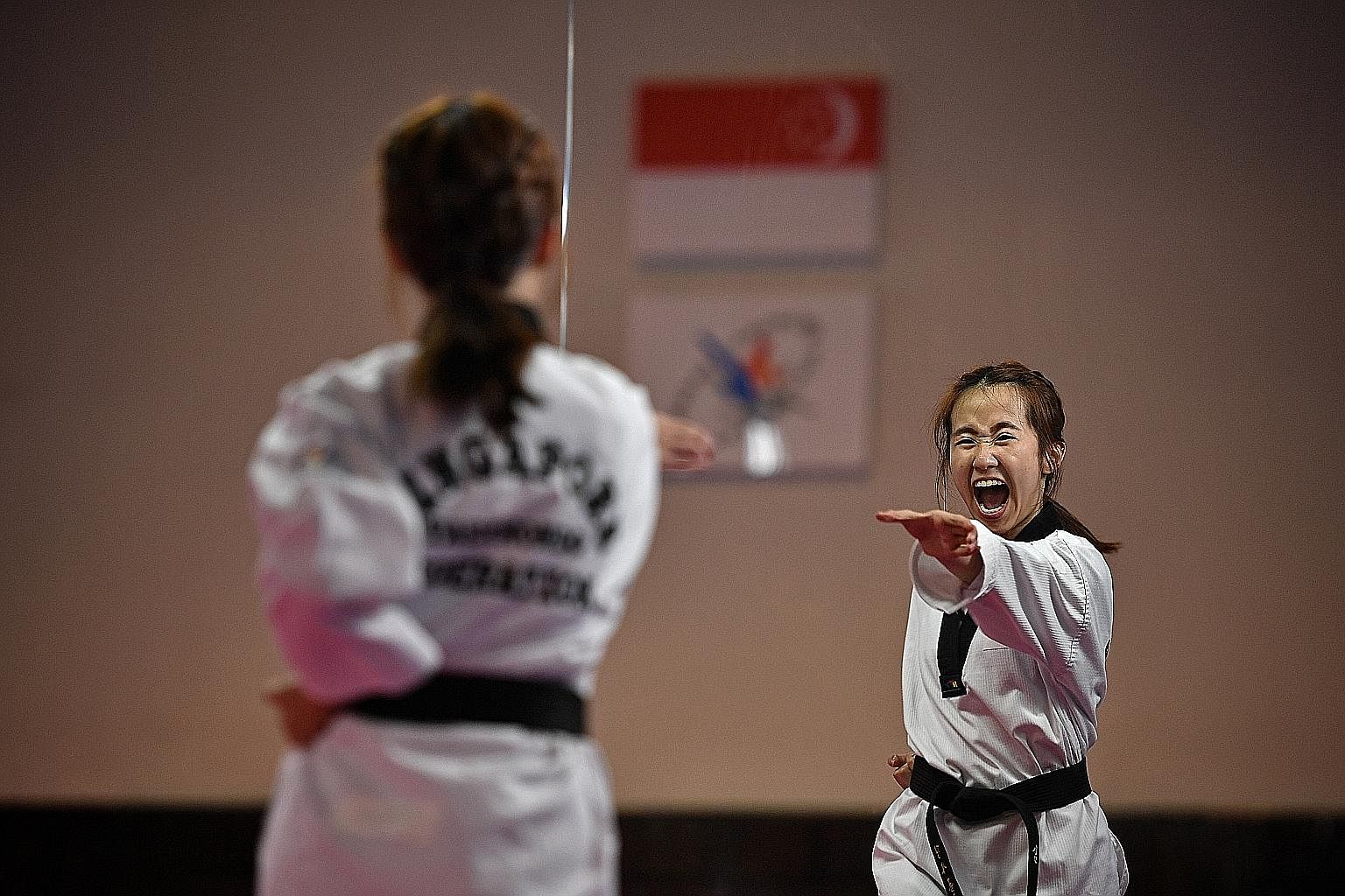 Ms Chelsea Ann Sim at a taekwondo training session last Wednesday at the national training centre for the Singapore Taekwondo Federation in Lorong Limau. The SEA Games gold medallist credits her family, coaches and friends in taekwondo for helping he