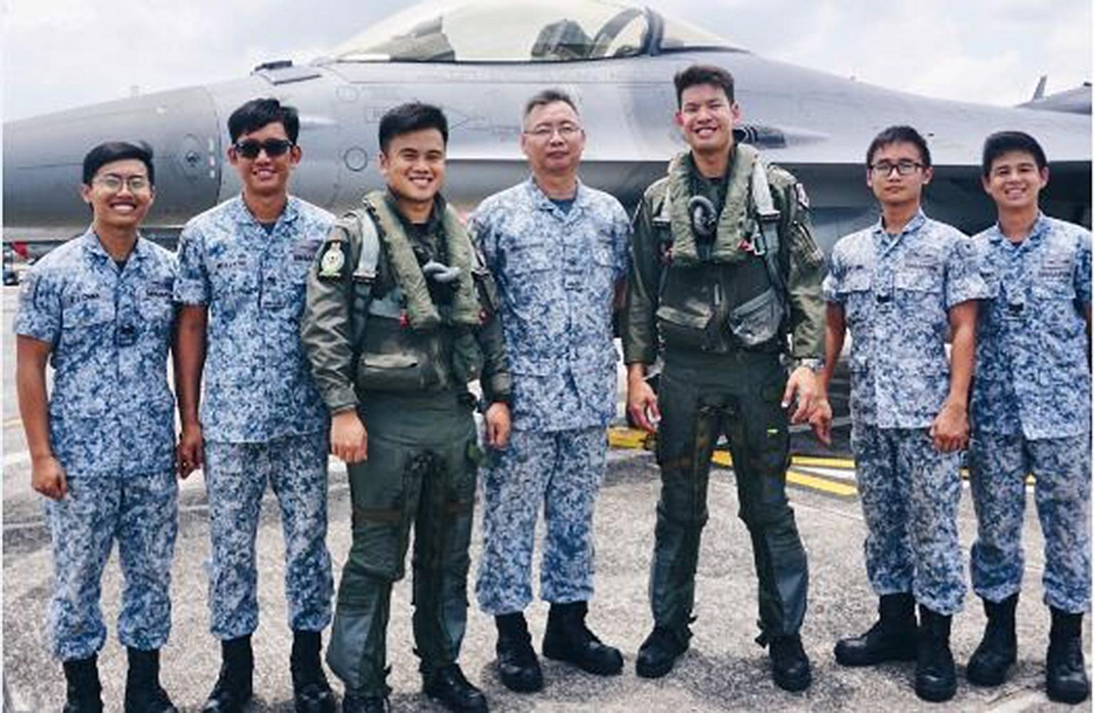 The two pilots - Major Jireh Ang and Captain Jonathan Ow Hsien-Kyn (third and fifth from left) - who flew the fighter jets scrambled yesterday, with their RSAF 143 Squadron colleagues (from left) Third Sergeant Melvin Chan Zhong Jun, Military Expert