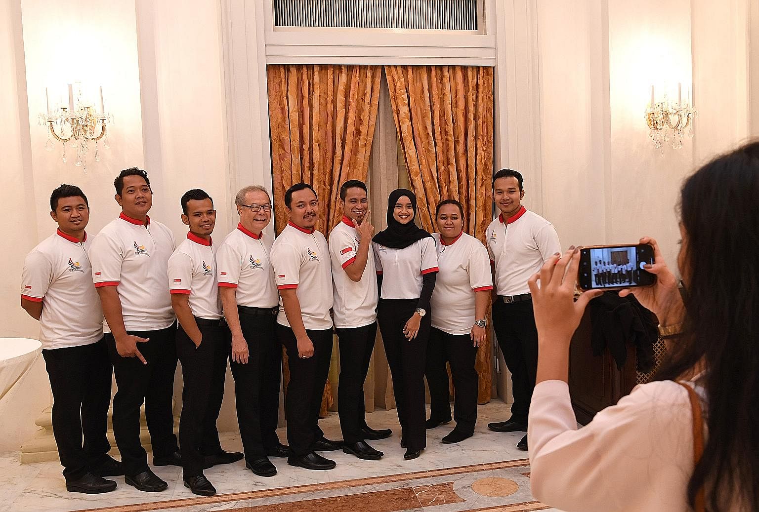 Members of the Singapore silat team posing for a photo at a dinner reception at the Istana yesterday. They were among 209 athletes and officials who were hosted by President Halimah Yacob in recognition of their efforts and achievements at five major