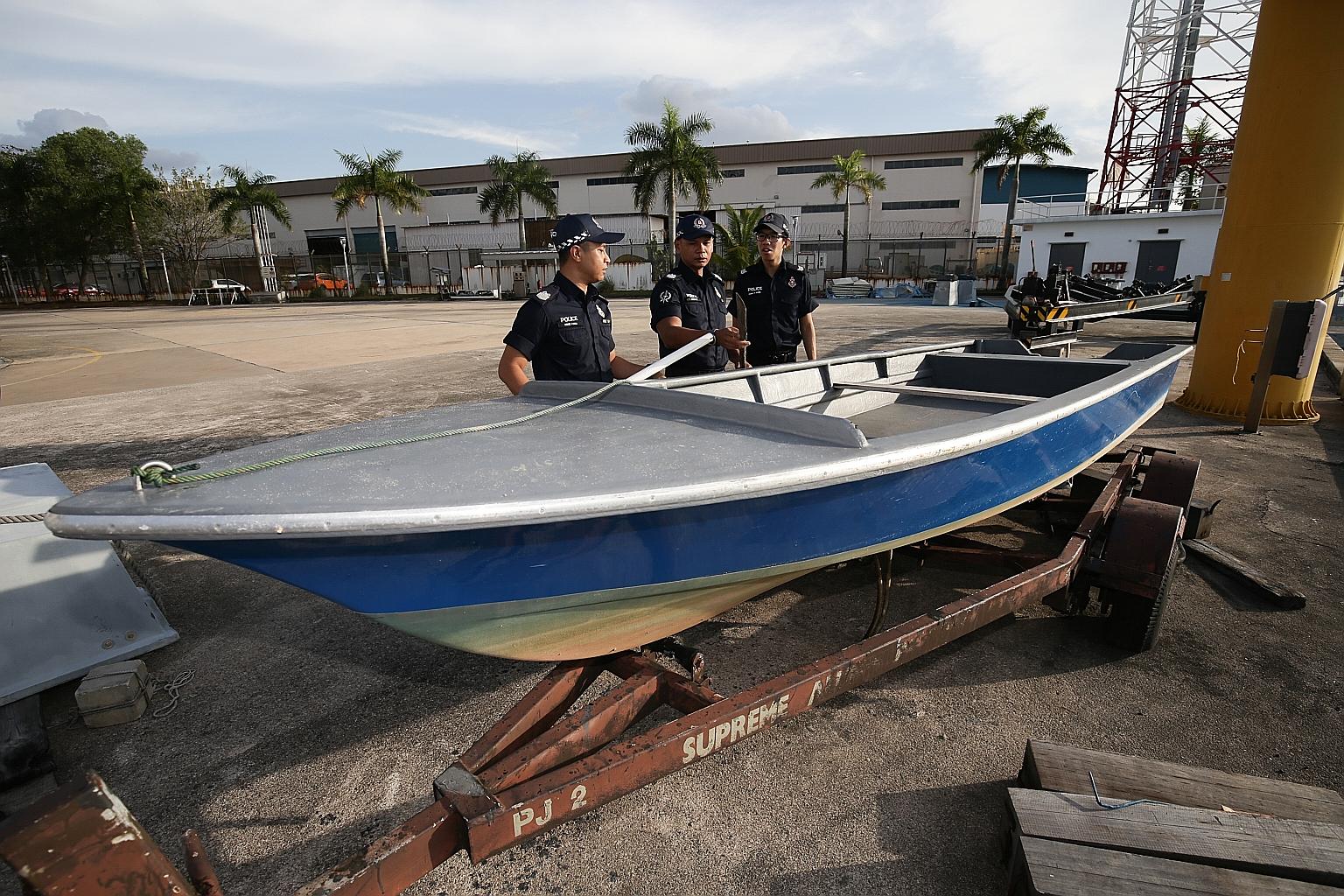 The fibreglass boat that was seized. A Bangladeshi and a Malaysian have been charged with illegal entry into Singapore.