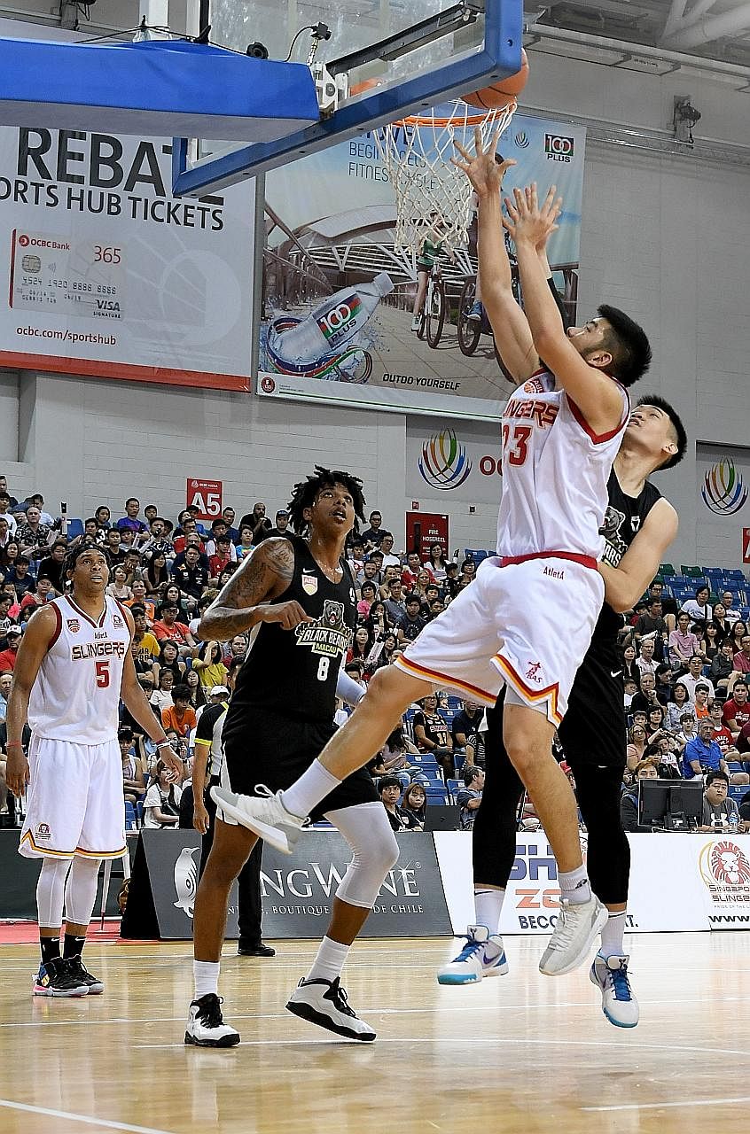 Delvin Goh outjumping two Macau Black Bears players at the OCBC Arena yesterday. He played a key role for the Singapore Slingers at both ends of the court, scoring on nine of his 10 field-goal attempts and grabbing eight rebounds in the 102-91 victor