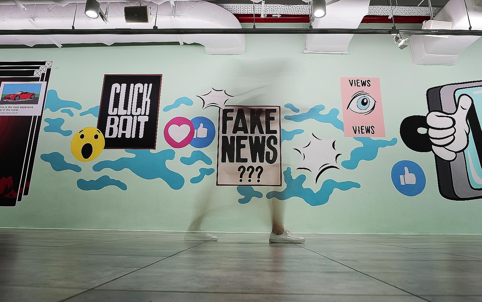 Graphics on the fake news issue in the underground pavement leading to the Esplanade last year. Law and Home Affairs Minister K. Shanmugam said leaving falsehoods to spread will crowd out legitimate debate.