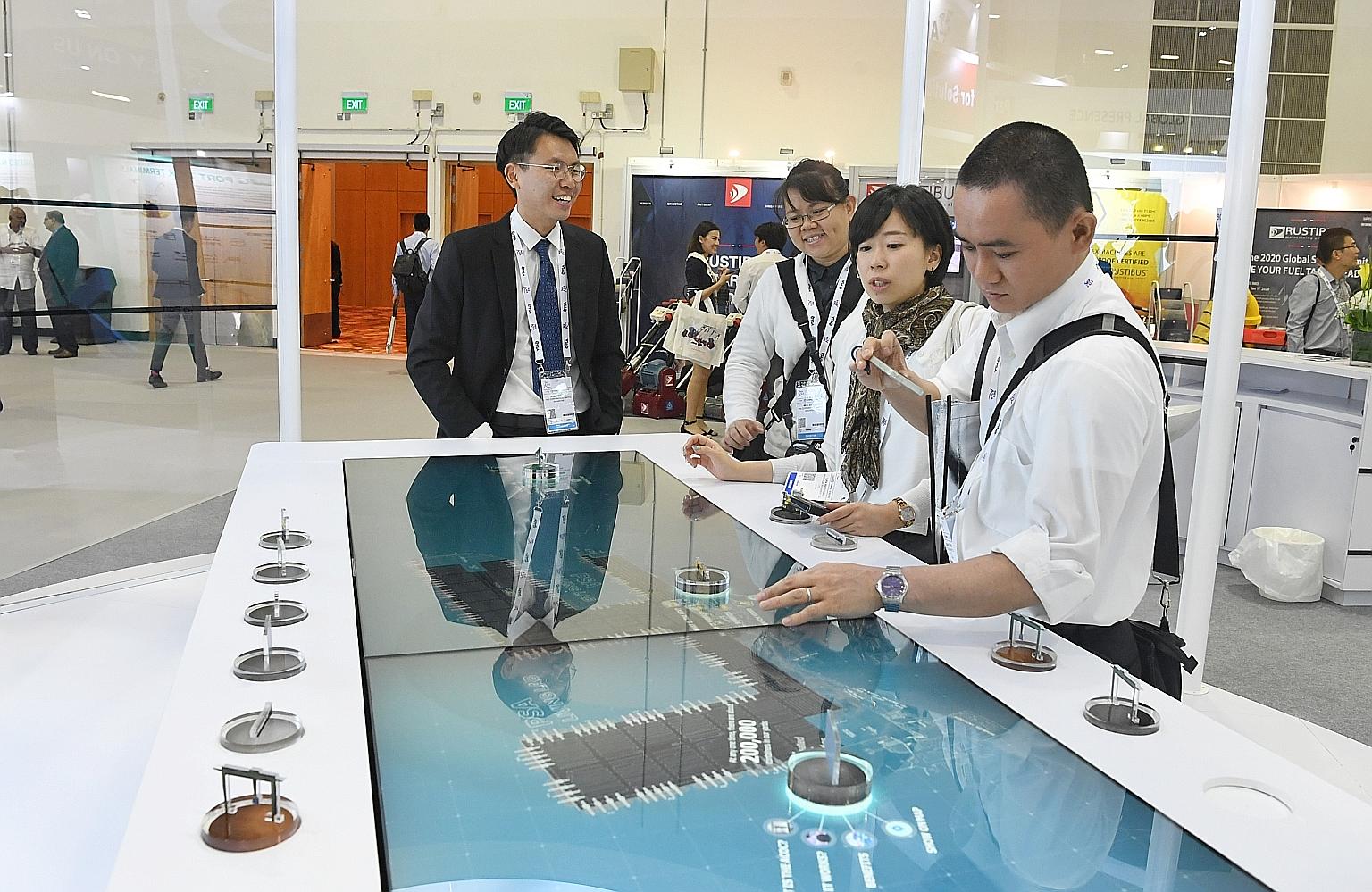 Visitors at a booth at the Sea Asia 2019 exhibition yesterday. The three-day event, with debates and discussions, aims to future-proof maritime leaders amid changes in technology as well as regulations.