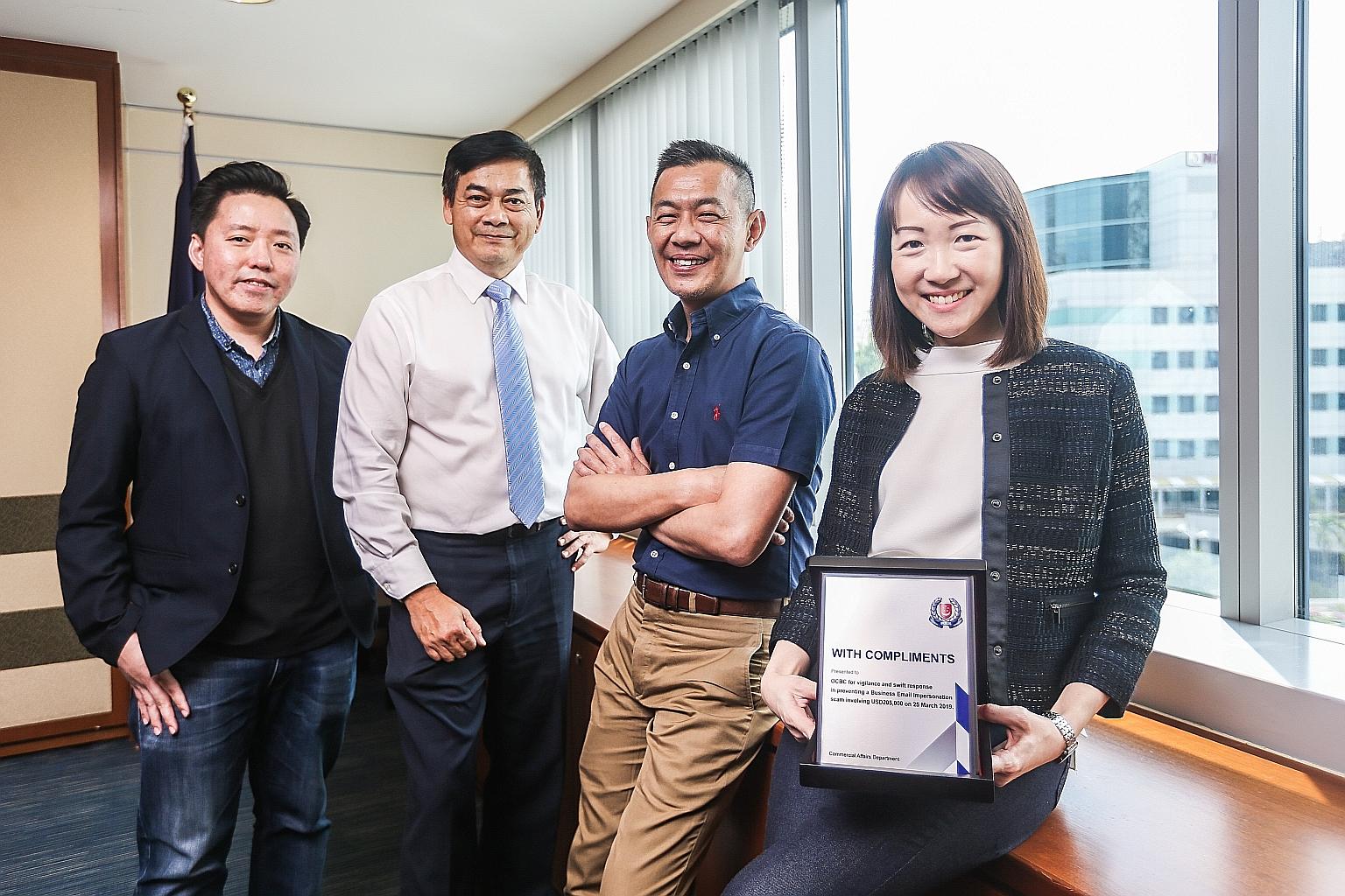 OCBC Bank staff with the Public Spiritedness Award (from left): Mr Royston Soon, assistant vice-president of fraud risk management; Mr Francisco John Celio, head of corporate security; Mr Ridhwan Khoo, head of fraud risk management; and Ms Angeline W