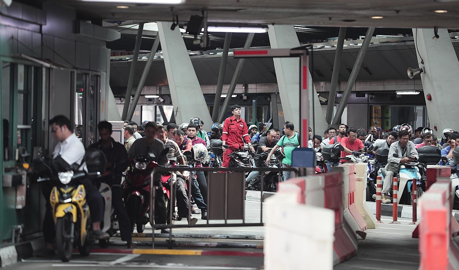 Traffic at Woodlands Checkpoint yesterday. The Government recently instituted new measures to bar vehicles with fines on them from entering the Republic until the fines are paid.
