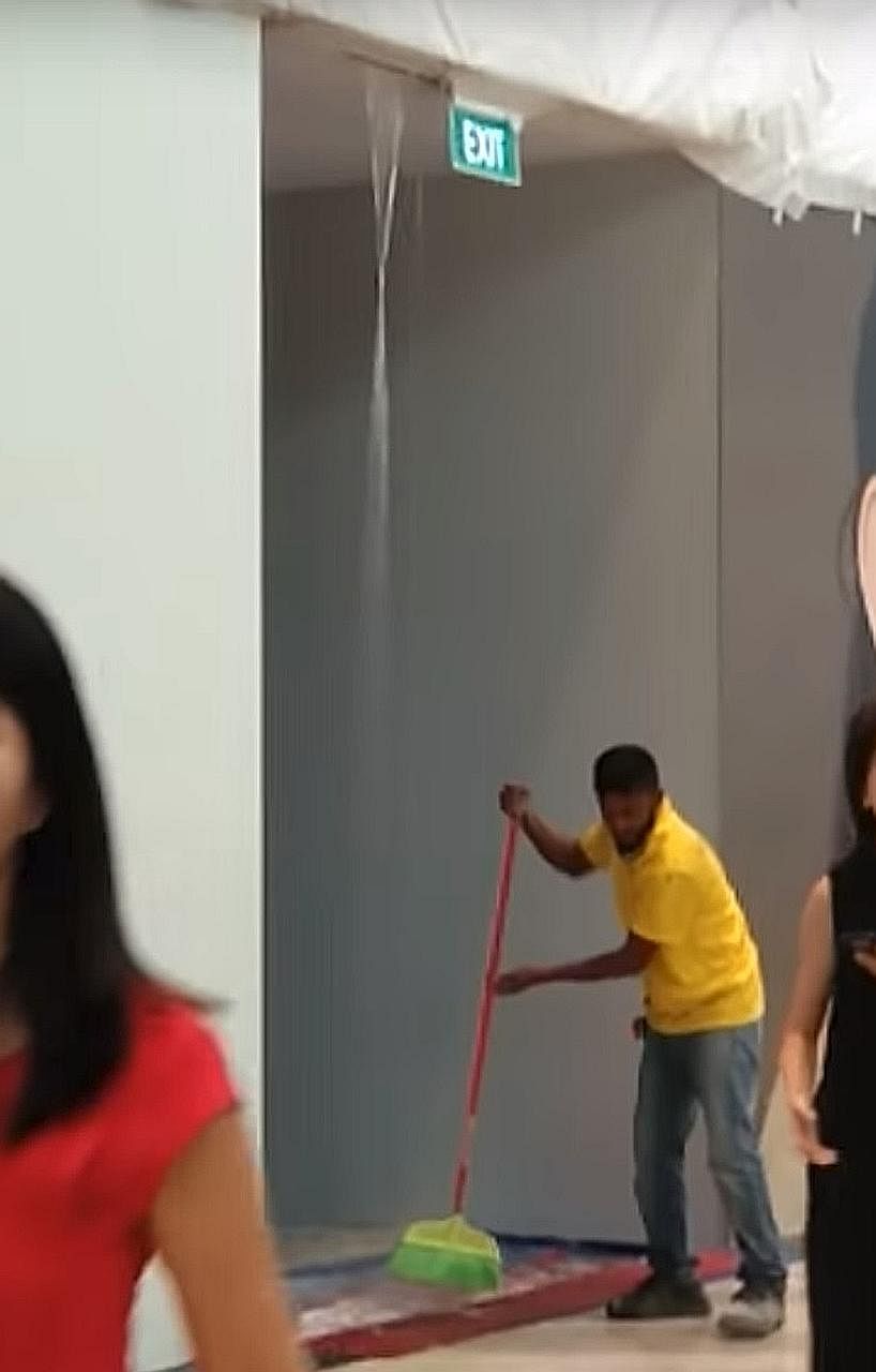 A worker cleaning up the floor that was covered in water leaking from the ceiling at Jewel Changi Airport on Saturday afternoon, the third day of a public preview. The complex will officially open on Wednesday. PHOTO: SCREENGRAB FROM SELICIA FELICIA/