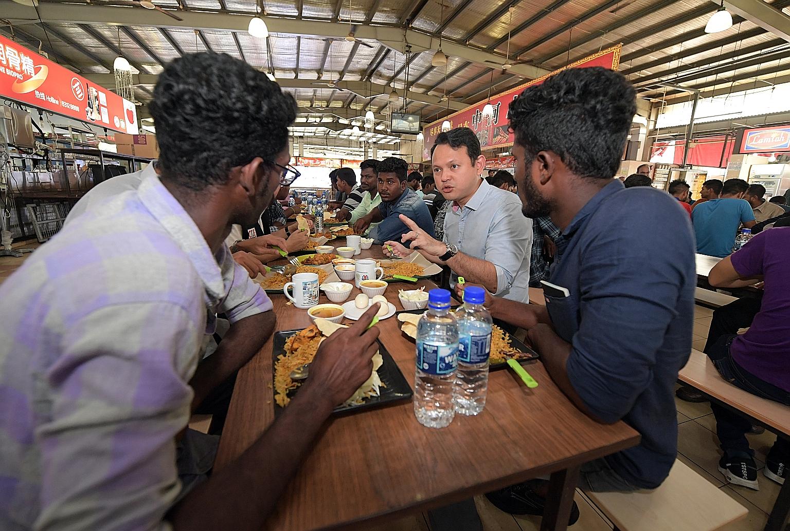 Minister of State for Manpower Zaqy Mohamad sharing a meal yesterday with foreign workers attending the Settling-In Programme at the SCAL Recreation Centre in Soon Lee Road. The one-day orientation course is currently compulsory for all new non-Malay