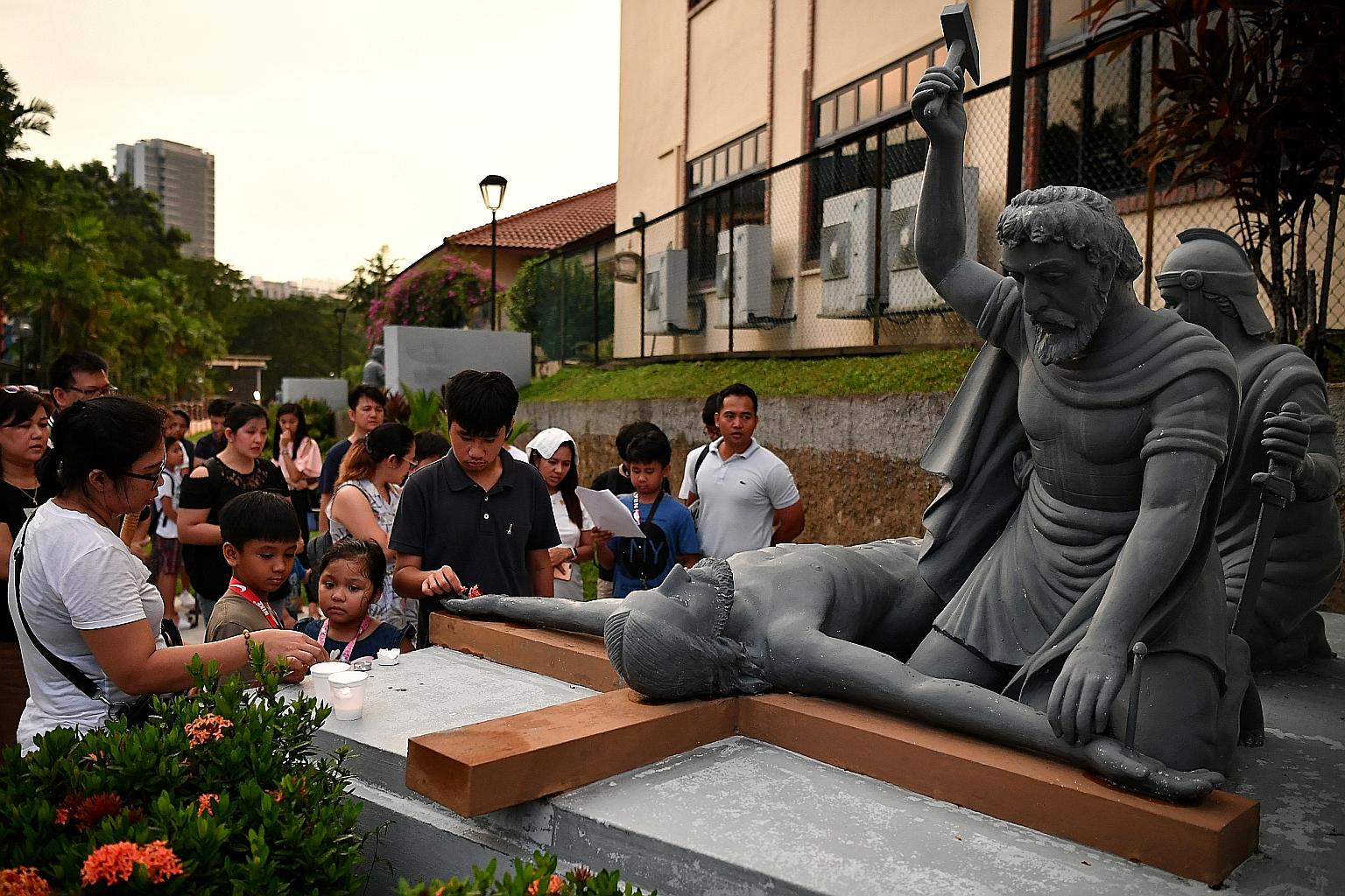 Worshippers praying at the 11th Station of the Cross - which commemorates the moment when Jesus was nailed to the Cross - at St Joseph's Church in Bukit Timah yesterday. The Way of the Cross - also known as the Stations of the Cross - is usually obse