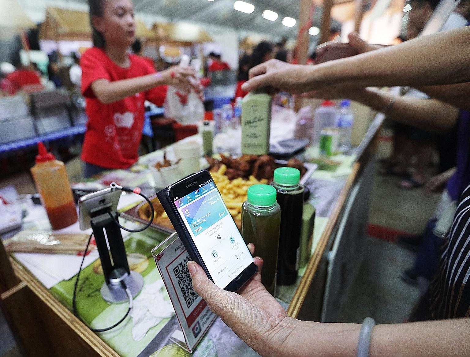 Fraud is a rising concern as more people now use e-wallets (left) on their smartphones. The guidelines contain new measures to better balance risky user behaviour with the potentially large losses that financial institutions are exposed to.