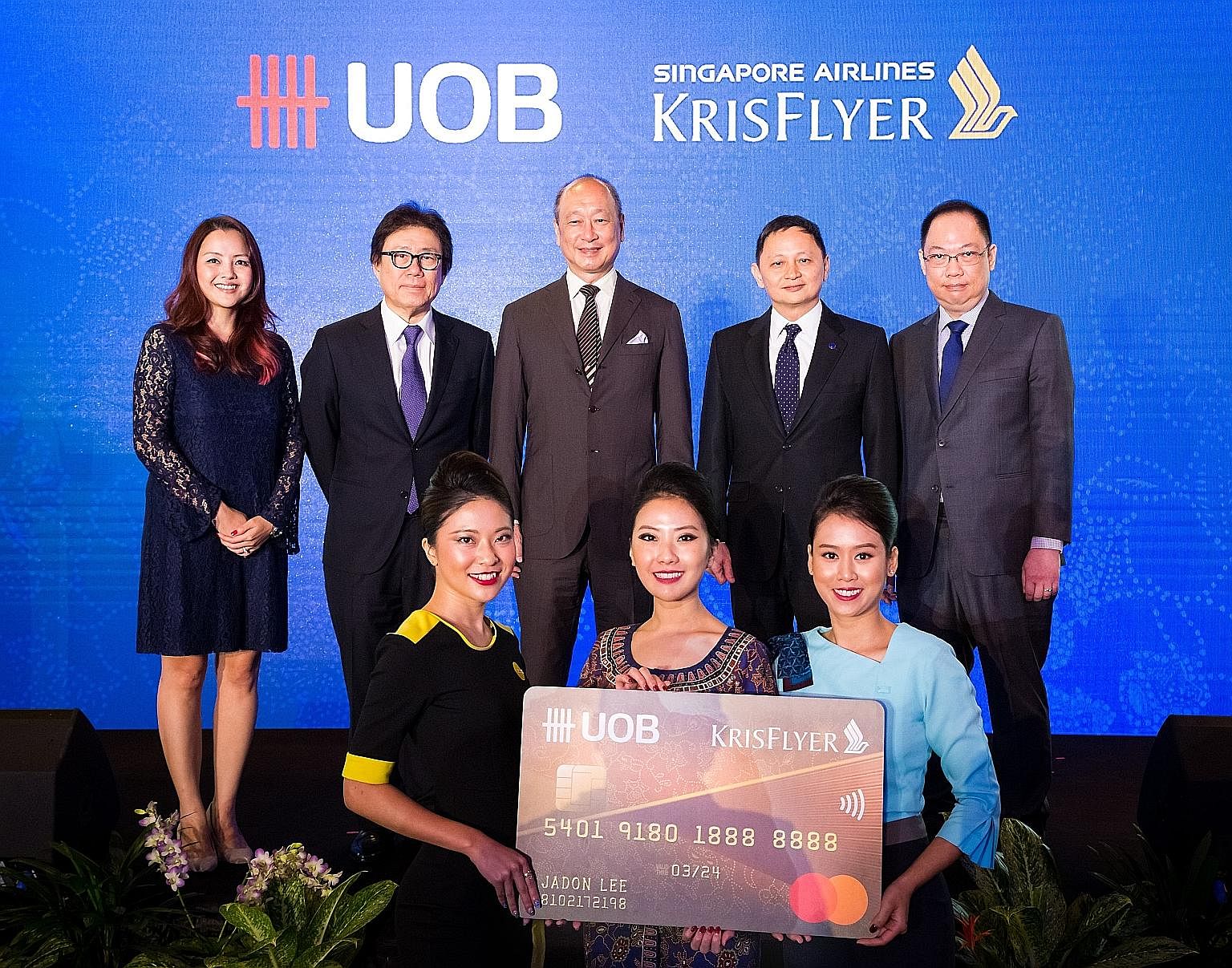 UOB CEO Wee Ee Cheong (centre, back row) and SIA Group CEO Goh Choon Phong (second from right) at the launch of the KrisFlyer UOB credit card.
