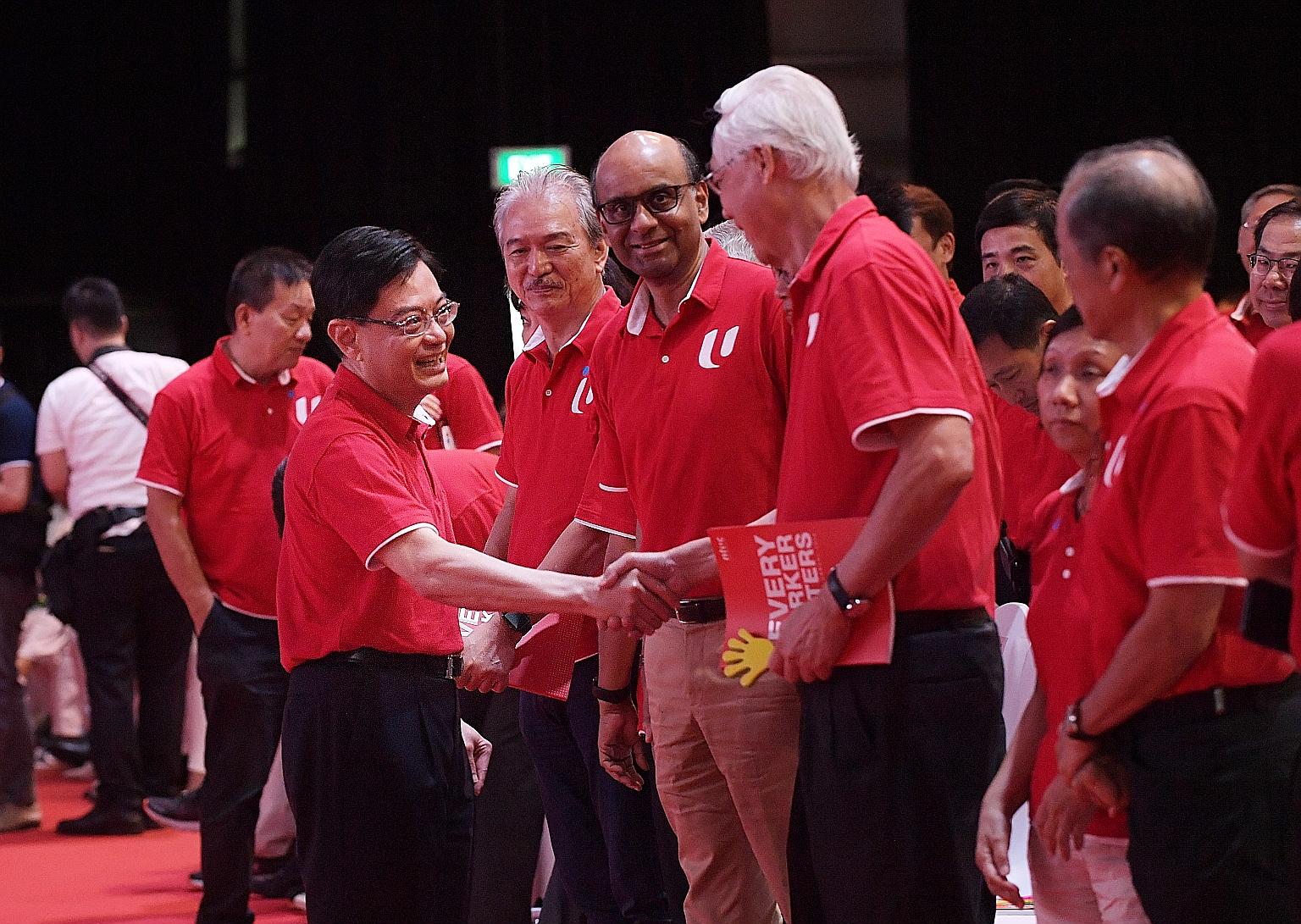 Deputy Prime Minister Heng Swee Keat greeting Emeritus Senior Minister Goh Chok Tong at Downtown East yesterday while Senior Minister Tharman Shanmugaratnam looked on. ST PHOTO: ALPHONSUS CHERN