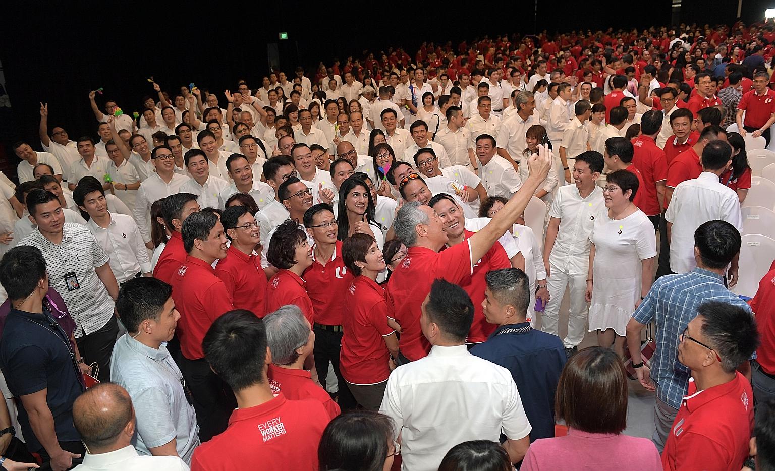 Prime Minister Lee Hsien Loong taking a wefie with Deputy Prime Minister Heng Swee Keat, other ministers and NTUC leaders, as well as the PAP contingent, at Downtown East yesterday. In his first May Day Rally speech, Mr Heng spoke of how the "close w