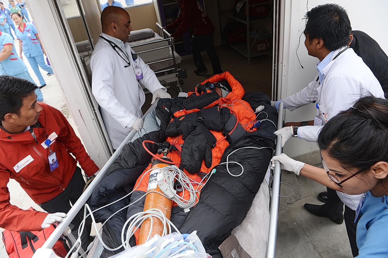 Medical staff and rescue personnel moving Malaysian climber Chin Wui Kin to a hospital bed after airlifting him to Mediciti Hospital in Lalitpur, on the outskirts of Kathmandu, last Friday. Dr Chin, whose condition was described as critical, was tran
