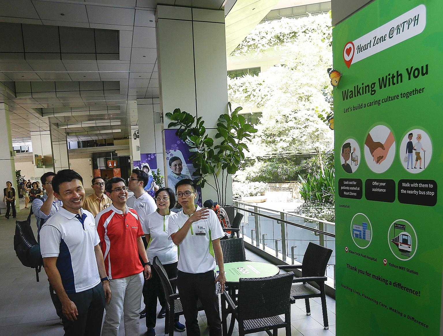 (From left) Senior Parliamentary Secretary for Transport, Mr Baey Yam Keng; adviser to Nee Soon GRC Grassroots Organisations Muhammad Faishal Ibrahim and Khoo Teck Puat Hospital (KTPH) chief executive Chew Kwee Tiang looking on as a KTPH employee exp