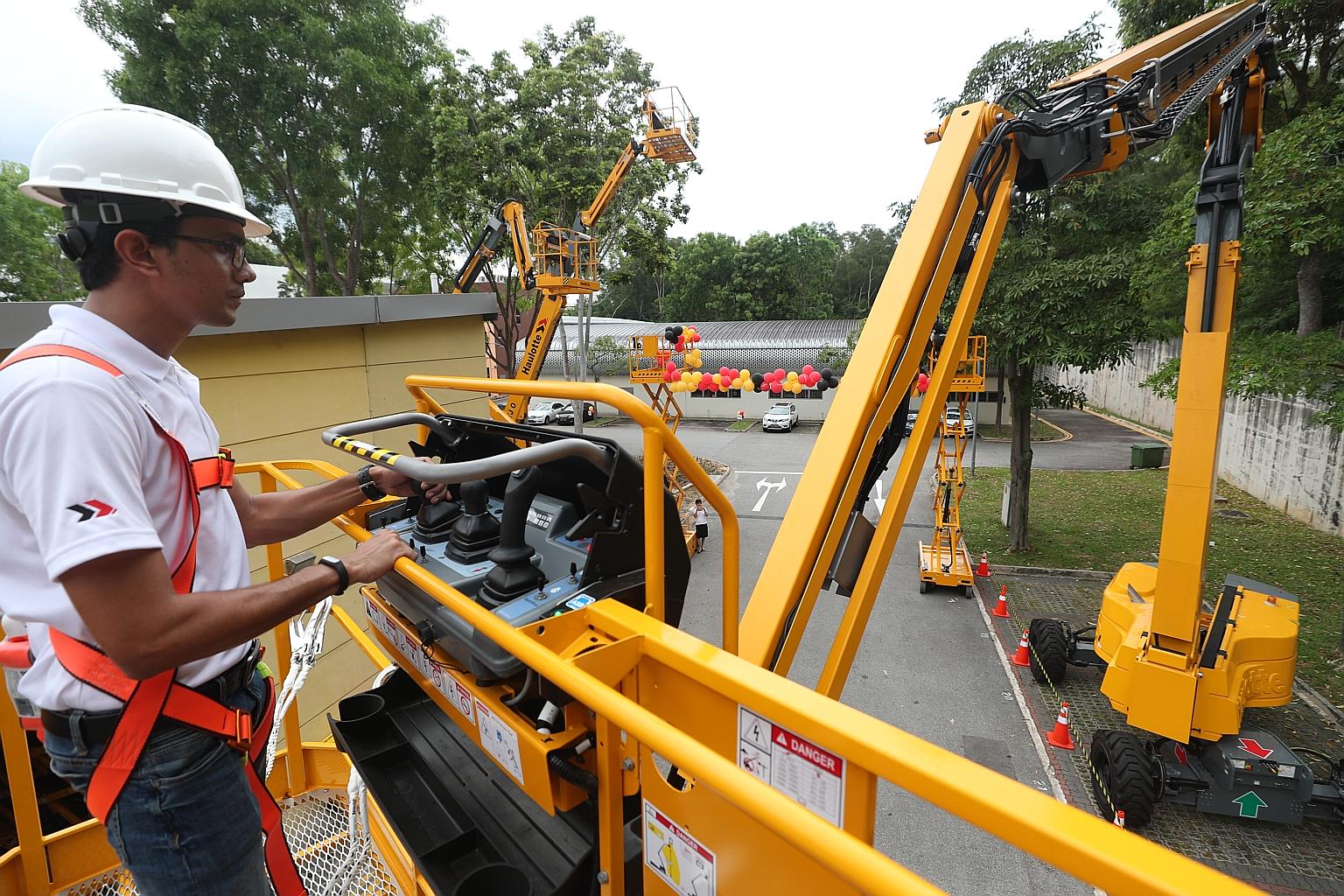 Haulotte trainer and service engineer Tin Maung Lynn operating the company's new and eco-friendly line of man lifts. Last month, Haulotte introduced the world's first fully electric man lift, a step up from diesel-powered ones, as part of a wider mov