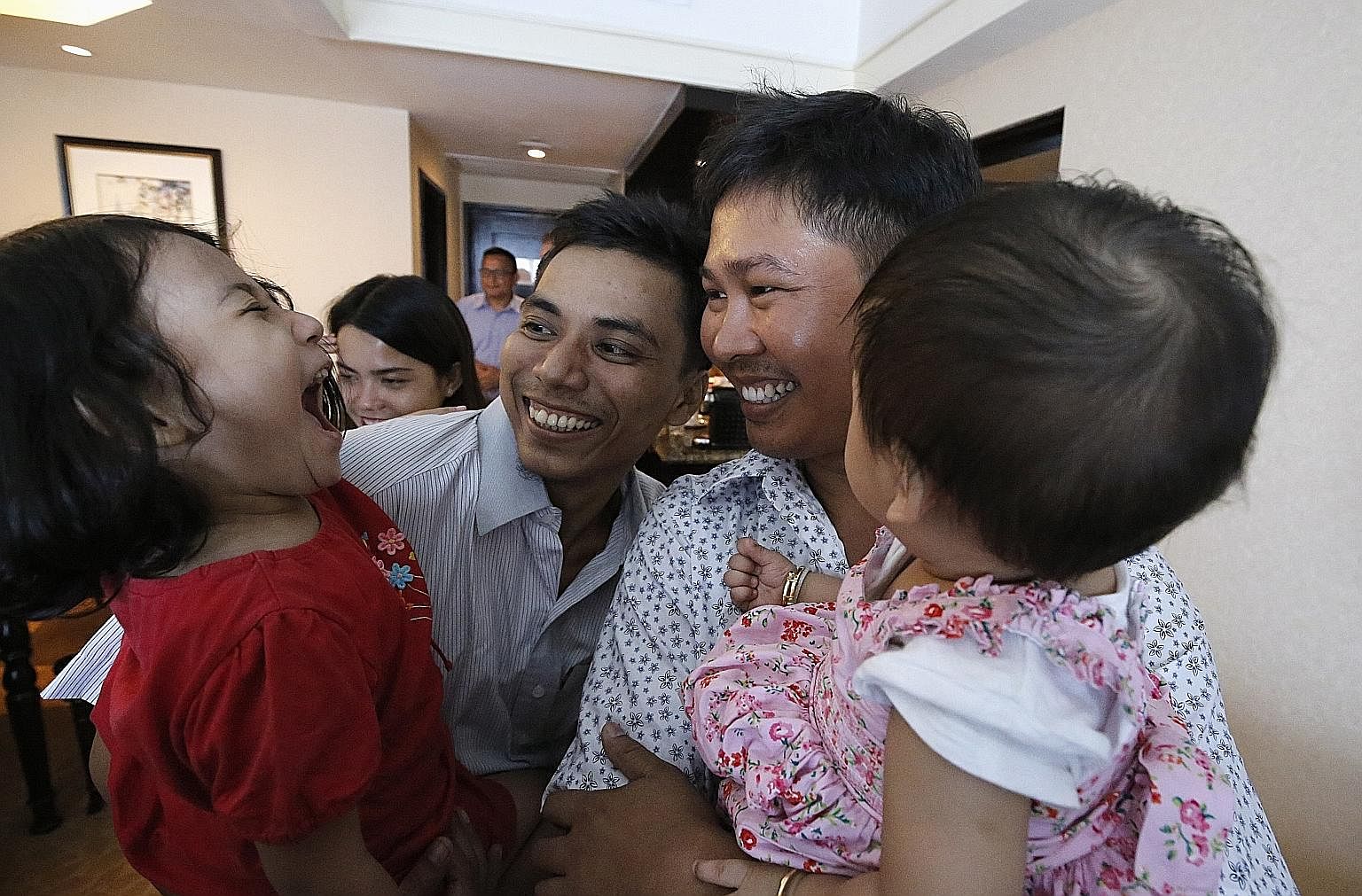 Myanmar journalists Kyaw Soe Oo (left) and Wa Lone, who were jailed over their coverage of the Rohingya crisis, celebrating with their daughters after they were freed in a presidential amnesty in Yangon yesterday. The award-winning Reuters journalist