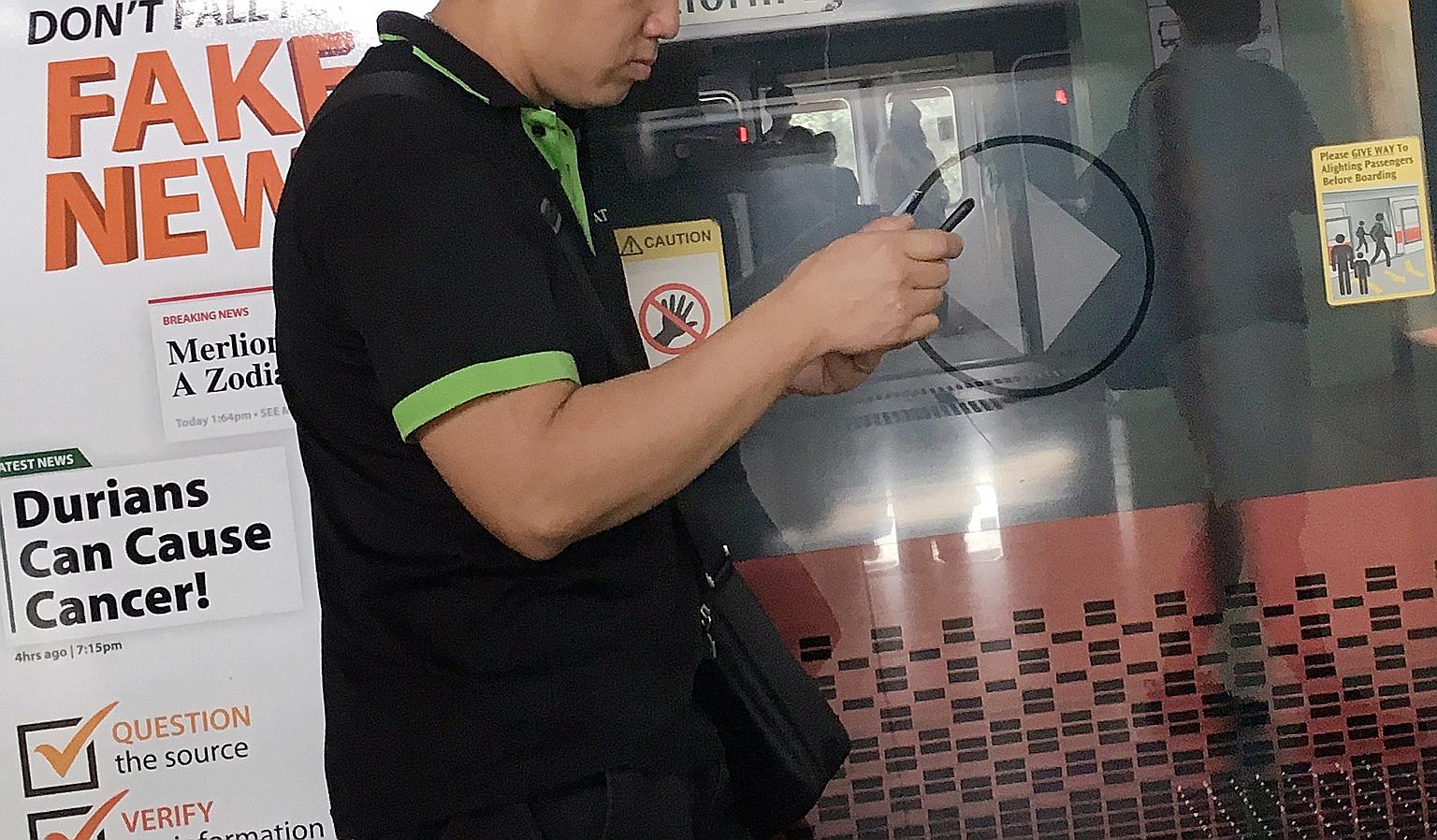 A poster warning about fake news at an MRT station in December last year. The new law gives ministers powers to order an individual to remove content that is deemed false or run a correction alongside it. It applies to statements of facts, and does n