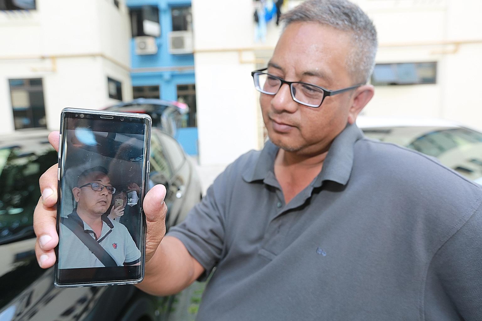 Gojek driver Kamaruzzaman Abdul Latiff playing his video of a spat with a passenger over the route he had taken.