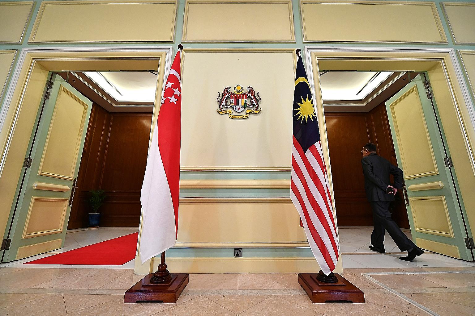 Singapore and Malaysia flags at the Perdana Putra building in Putrajaya, where Prime Minister Lee Hsien Loong and his Malaysian counterpart Mahathir Mohamad met for the leaders' retreat last month. ST PHOTO: LIM YAOHUI