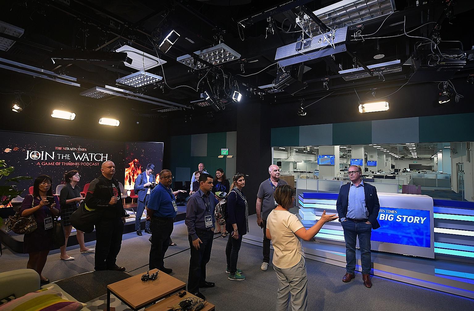 Delegates of Publish Asia 2019 getting a look at what goes on behind the scenes of The Straits Times' new daily talk show, The Big Story, in its broadcast studio.