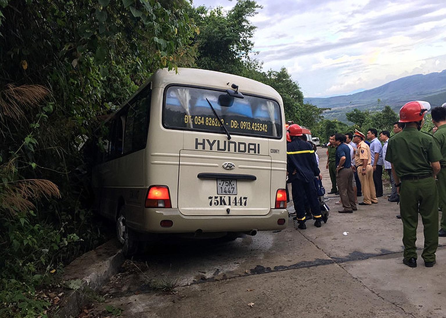 Emergency personnel at the scene of the accident in the central city of Hue, in Vietnam, last Saturday. One of the two buses carrying the students hit a kerb, and all 20 students on board were flung from their seats.