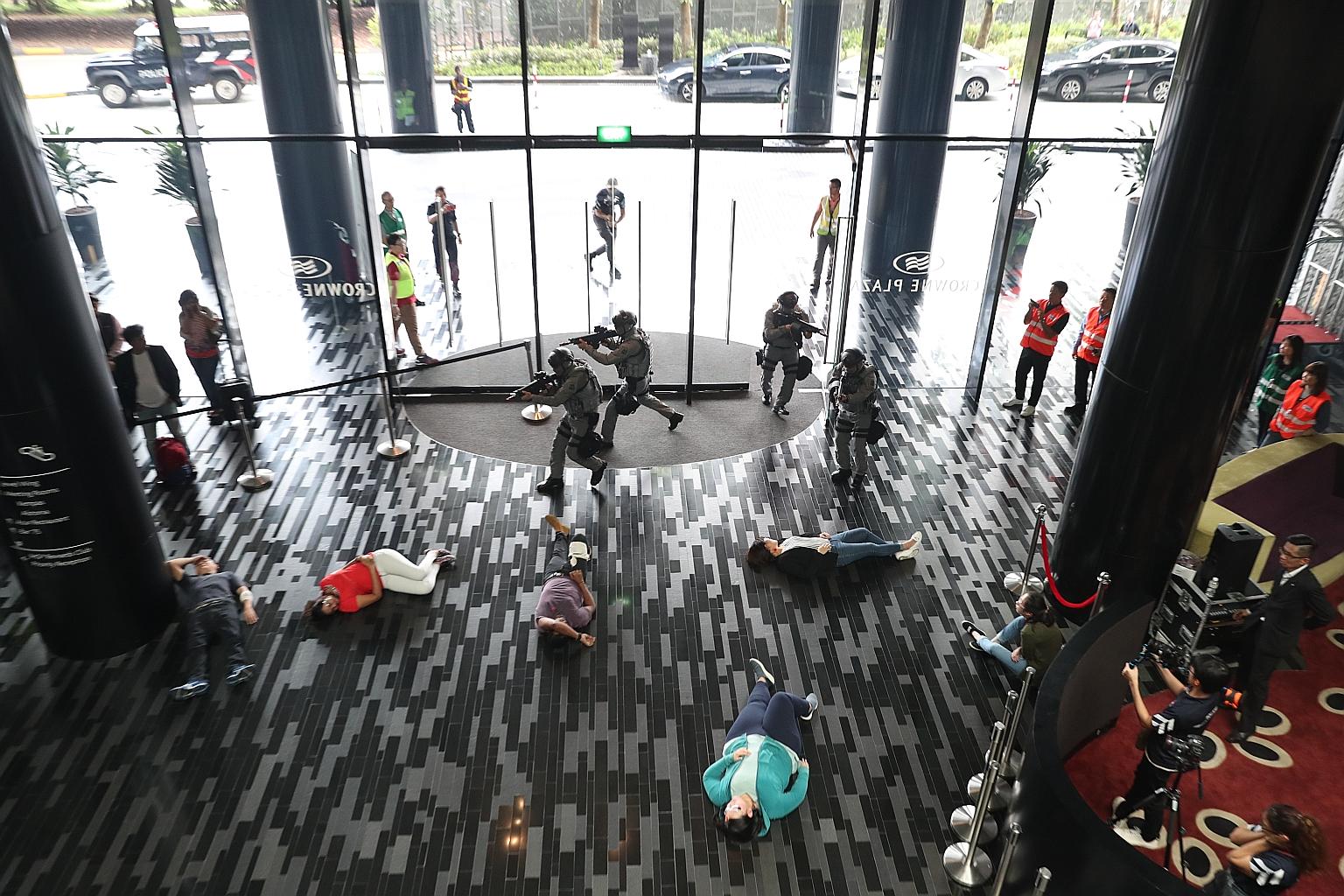 Members of the Gurkha contingent storming the Crowne Plaza Changi Airport yesterday to take down three "gunmen" during Exercise Heartbeat, a counter-terror simulation exercise.