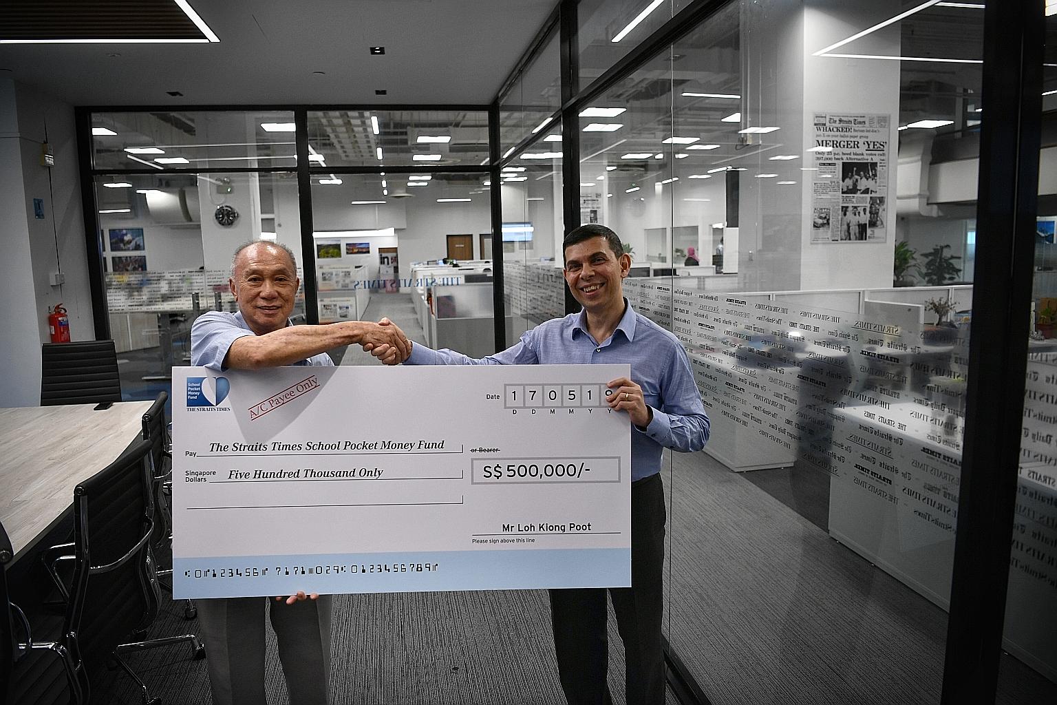 Retired businessman Loh Kiong Poot presenting a cheque for $500,000 to Mr Warren Fernandez, chairman of The Straits Times School Pocket Money Fund, at The Straits Times newsroom yesterday. Mr Loh, who also gave $500,000 to the fund last year, said he