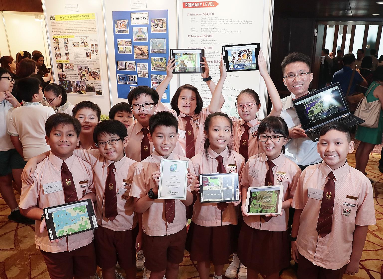 Aidin Faiz Ahmad Ismadi (far right in front row) and his fellow teammates from Temasek Primary School who shared the first prize - with their Westwood Primary counterparts - in the primary school category of the Green Wave Environmental Care Competit