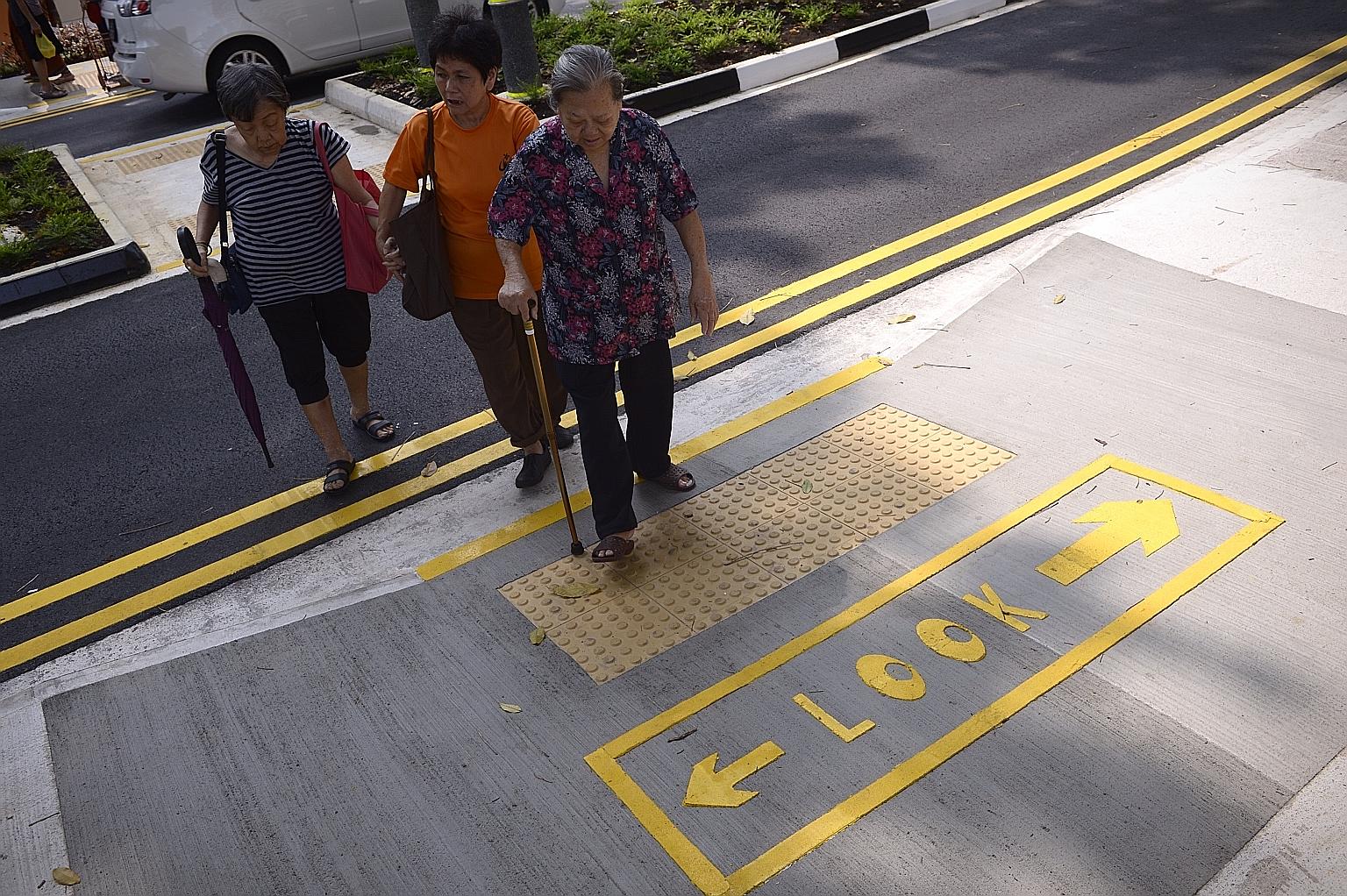A Silver Zone crossing in Bukit Merah. These zones, with narrowing roads and wider centre dividers, were introduced in 2014 to make it safer for seniors crossing roads. The Land Transport Authority is planning to lower the road speed limit in some zo