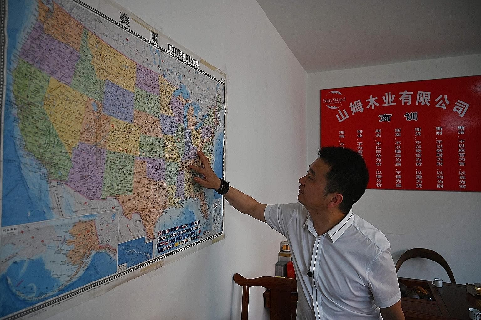 Mr Xu Xuebing, founder of China firm Sam Wood, showing where in the United States his company imports wood from. While China is ahead in some crucial areas, such as artificial intelligence, it is behind and dependent on foreign sources - especially t