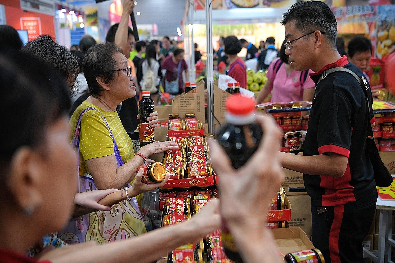Visitors buying items at the Singapore Food Expo. This year's event features more than 130 local food brands, such as Swatow Seafood, Bee Cheng Hiang and Yummi House.