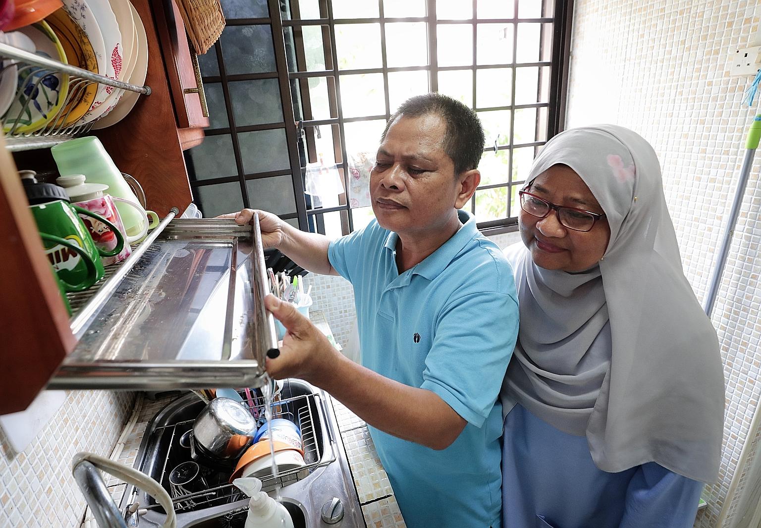 Chai Chee Road resident Zainodin Mohamad, 56, and his wife, Madam Sumarni Surana, 55, checking their kitchen for potential mosquito breeding habitats. The Chai Chee Road area is the third largest dengue cluster in Singapore. The first two are in Wood