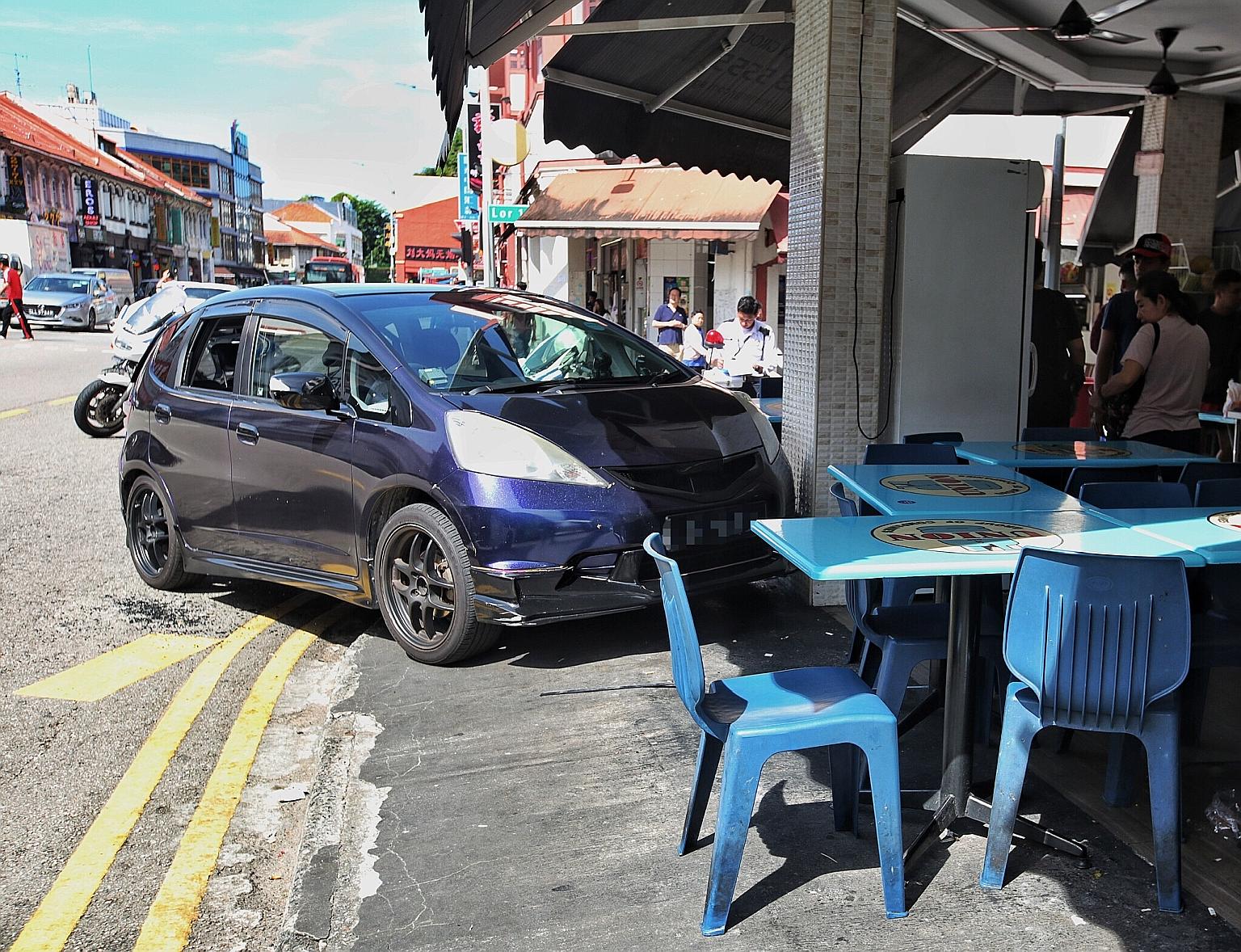 A driver lost control of her car along Geylang Road, which mounted the kerb and crashed into ABC Bistro. PHOTO: LIANHE ZAOBAO