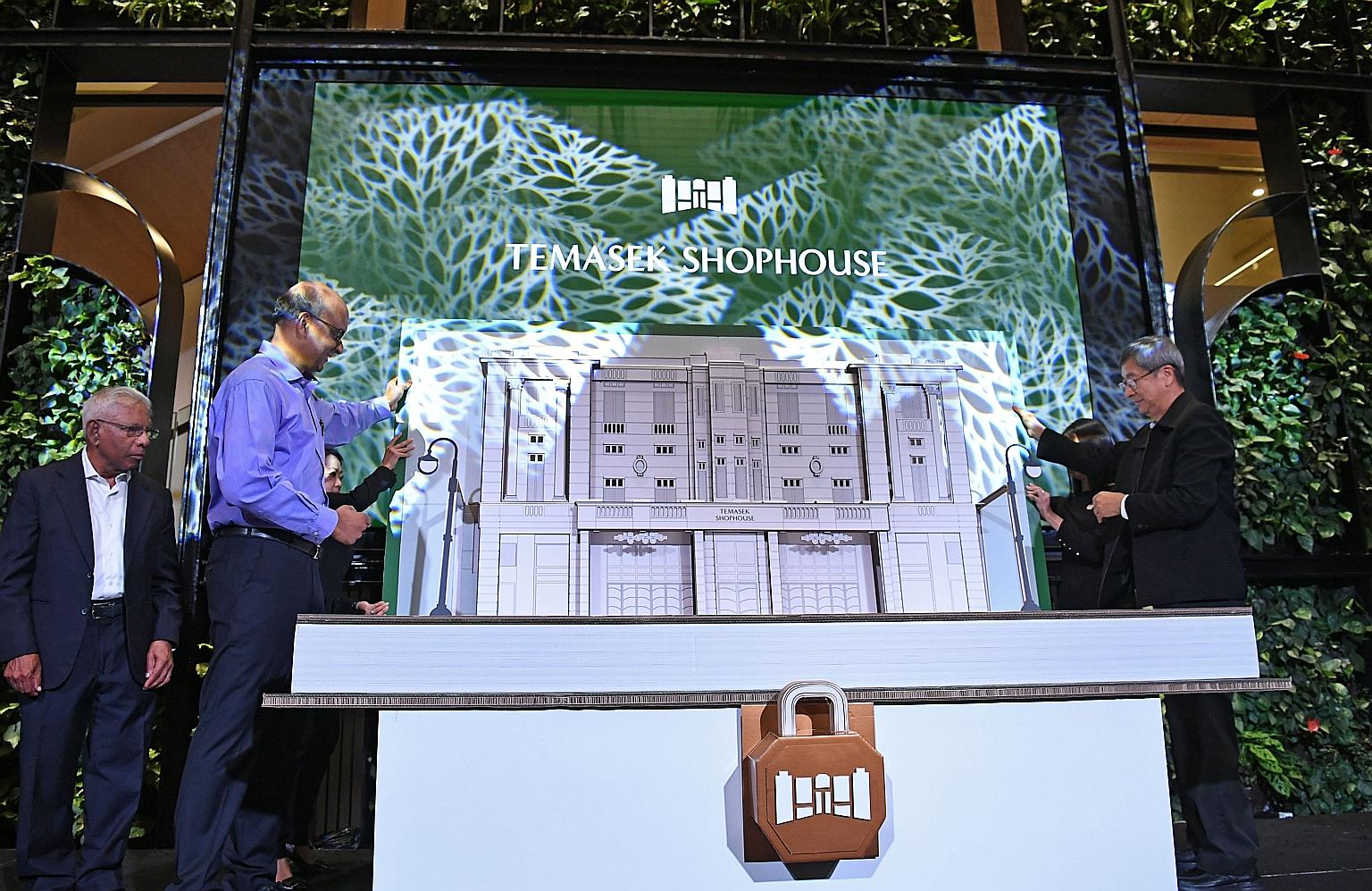 Senior Minister Tharman Shanmugaratnam and Temasek chairman Lim Boon Heng officiating the opening of Temasek Shophouse yesterday, with Temasek Trust chairman S. Dhanabalan (left) looking on. The new 25,000 sq ft space is a co-working hub for social e
