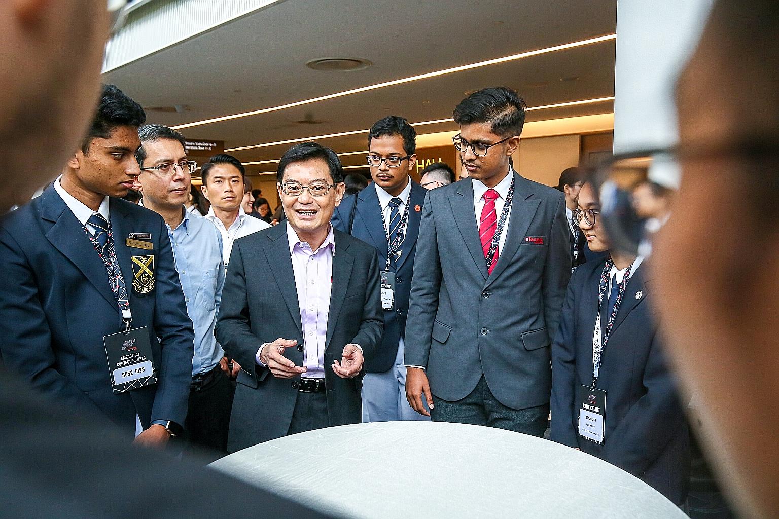 Deputy Prime Minister Heng Swee Keat speaking to students who attended the annual Pre-University Seminar yesterday. He urged them to venture into the fast-growing region, noting that many Asian companies are among the most innovative and best regarde