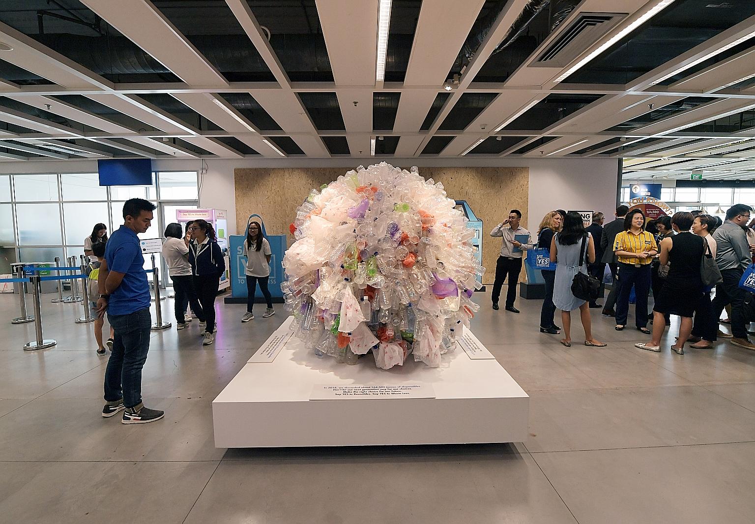 A sculpture made of plastic bottles and plastic bags at Ikea Tampines yesterday. Last year, about 164,500 tonnes of domestic waste here was made up of disposables - enough to fill about 300 Olympic-size swimming pools.