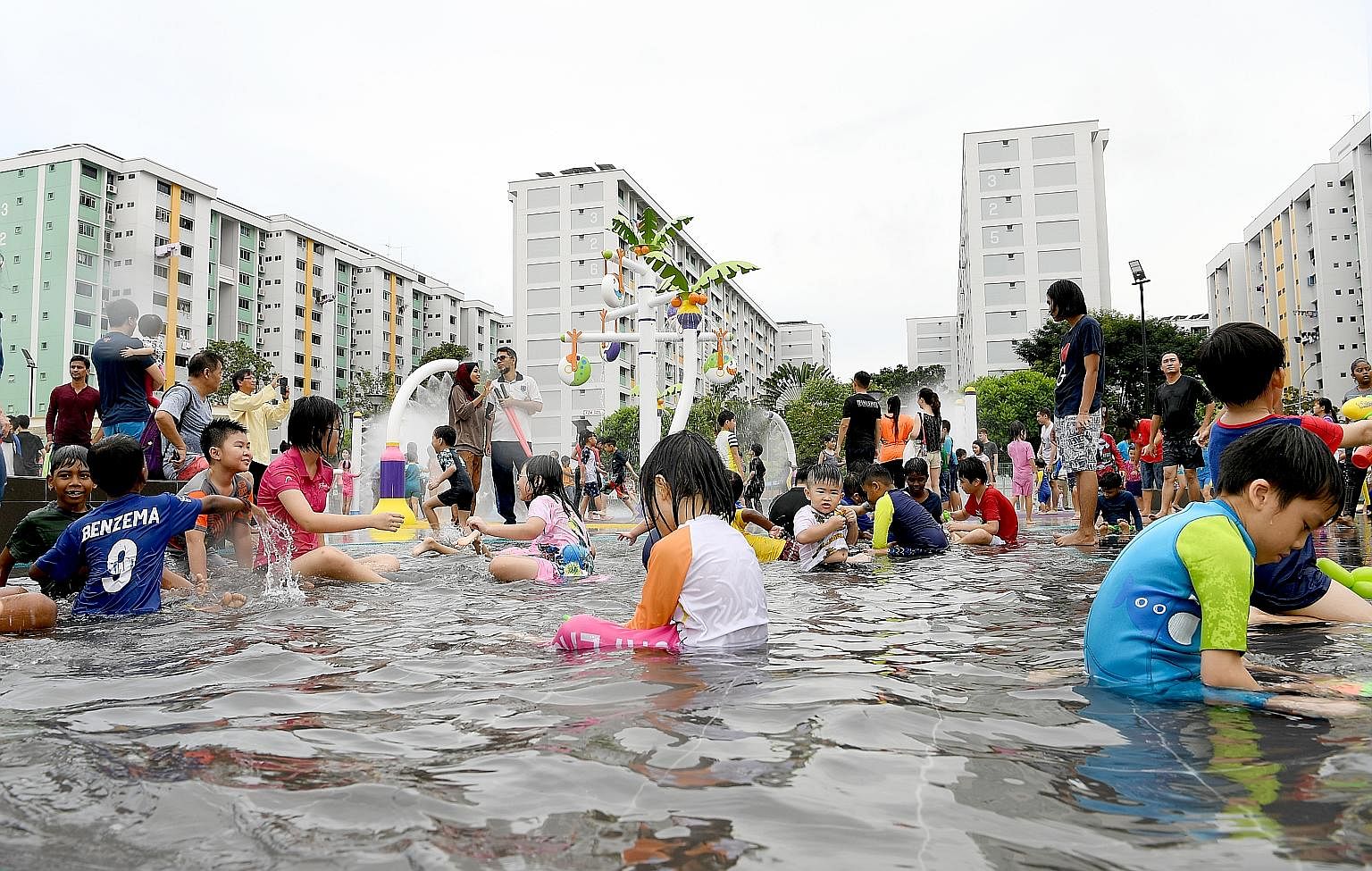 Children playing in a shallow pool at the Oasis Waterpark @ Nee Soon East. The 5,600 sq m park in Yishun Central, about 10 minutes' walk from Yishun MRT station, opened yesterday after 10 months of construction at a cost of $1.3 million. It is billed