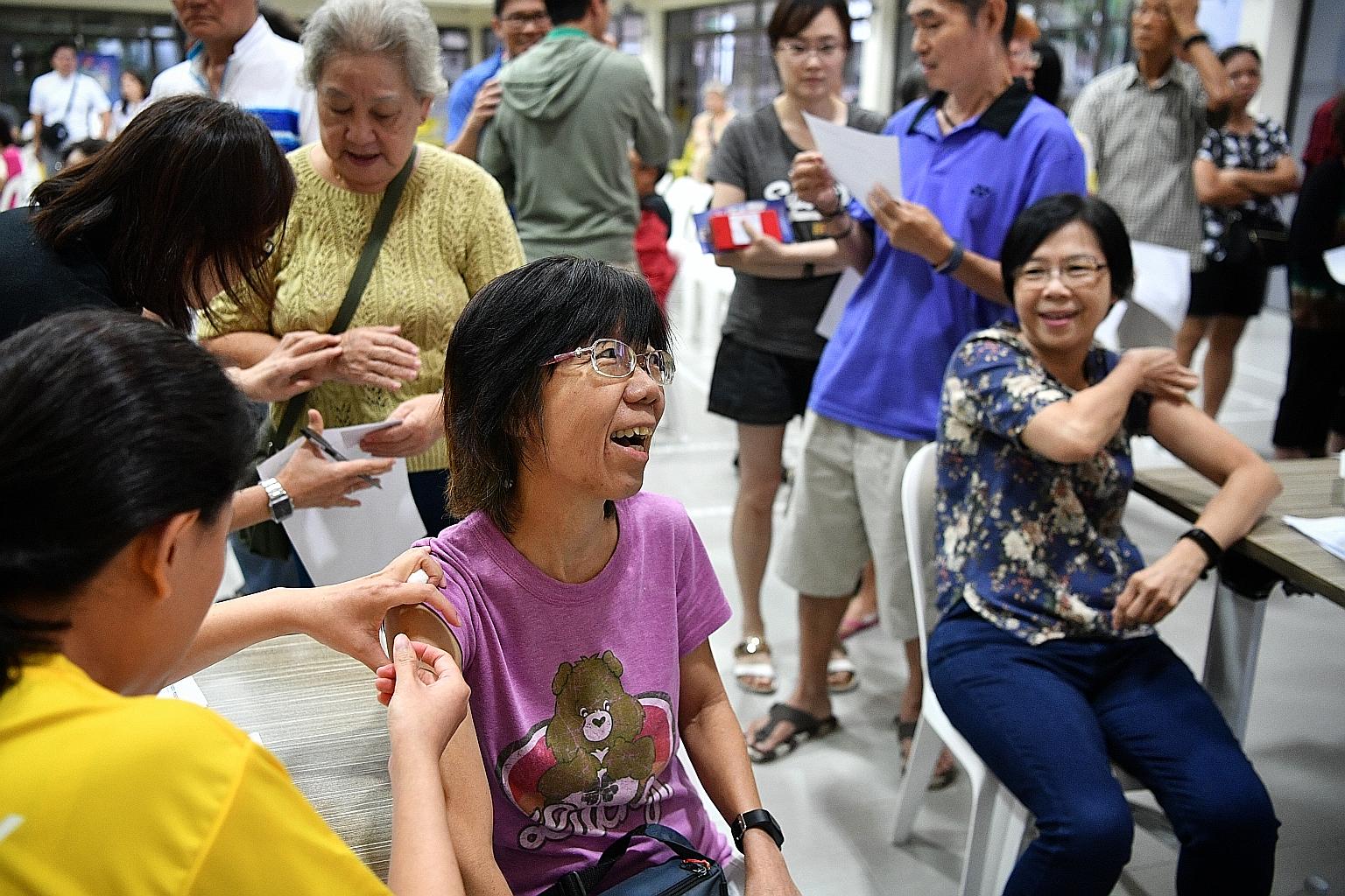 Madam Joyce Lai, 56, getting a flu jab at the Leng Kee Community Club yesterday. She was one of 175 residents from the Queenstown precinct who participated in the mass flu vaccination exercise organised by the Queenstown Citizens' Consultative Commit