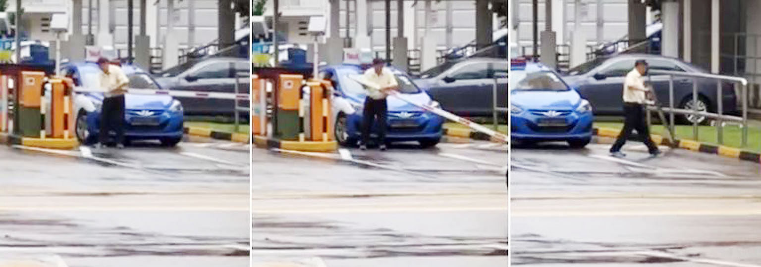 Screen grabs from the widely shared video show the taxi driver tugging at the barrier arm of the HDB carpark at Jurong East Street 32 before detaching it and throwing it on the side of the road.