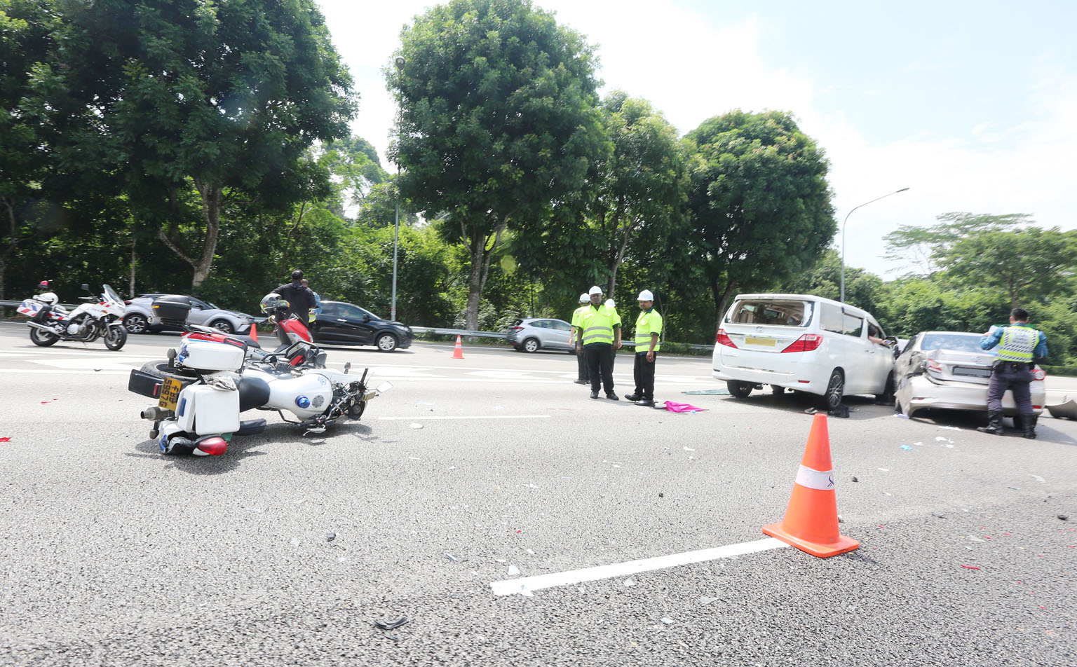 The site of the accident on Sunday, where a car skidded and hit a Traffic Police officer and an SCDF paramedic, who were attending to earlier accidents along the Pan-Island Expressway. PHOTO: SHIN MIN DAILY NEWS