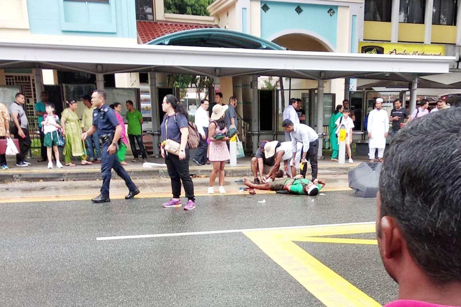 Mr Dhines Selvarajah lying injured on the ground in Serangoon Road on July 25 last year. The police nabbed the five attackers within 16 hours of the attack. PHOTO: TNP READER