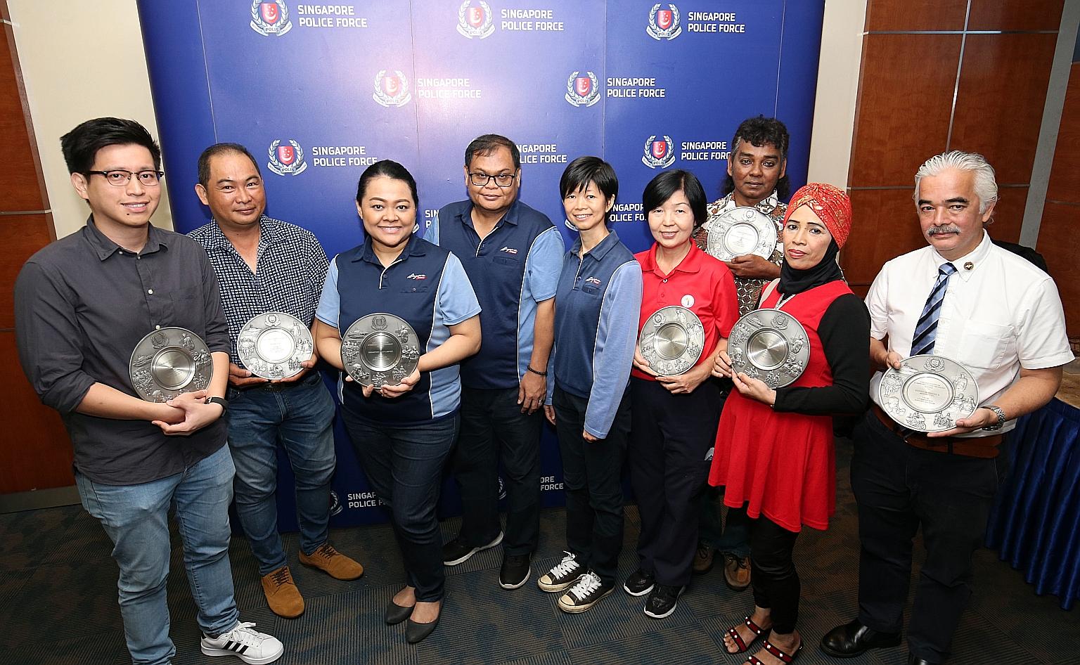 Receiving the awards yesterday were (from left): Mr Edmund Shao; Mr Tan Kay Huat, who helped to stop a man from stealing cash cards from vehicles; SingPost's Nora Yasmin Mohamed Zain, Tahir Saleh and Lee Mei Chan; Ms Winnie Tan, with Mr Abdul Hamid A