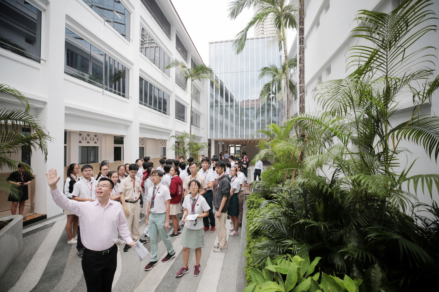 Ministry of Law deputy secretary Han Kok Juan with the youth ambassadors at the Maxwell Chambers Suites yesterday, where the students were taken on a tour. The students will undergo a five-day training course jointly organised by different agencies, 